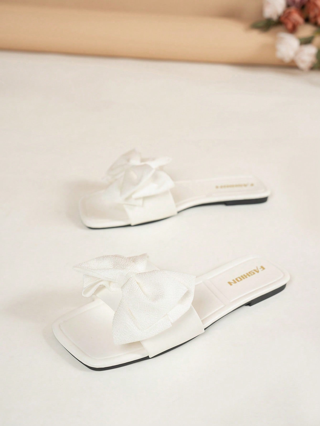 Women's flat slide sandals with a square open toe, geometric detail, and PU leather construction with rubber outsole.