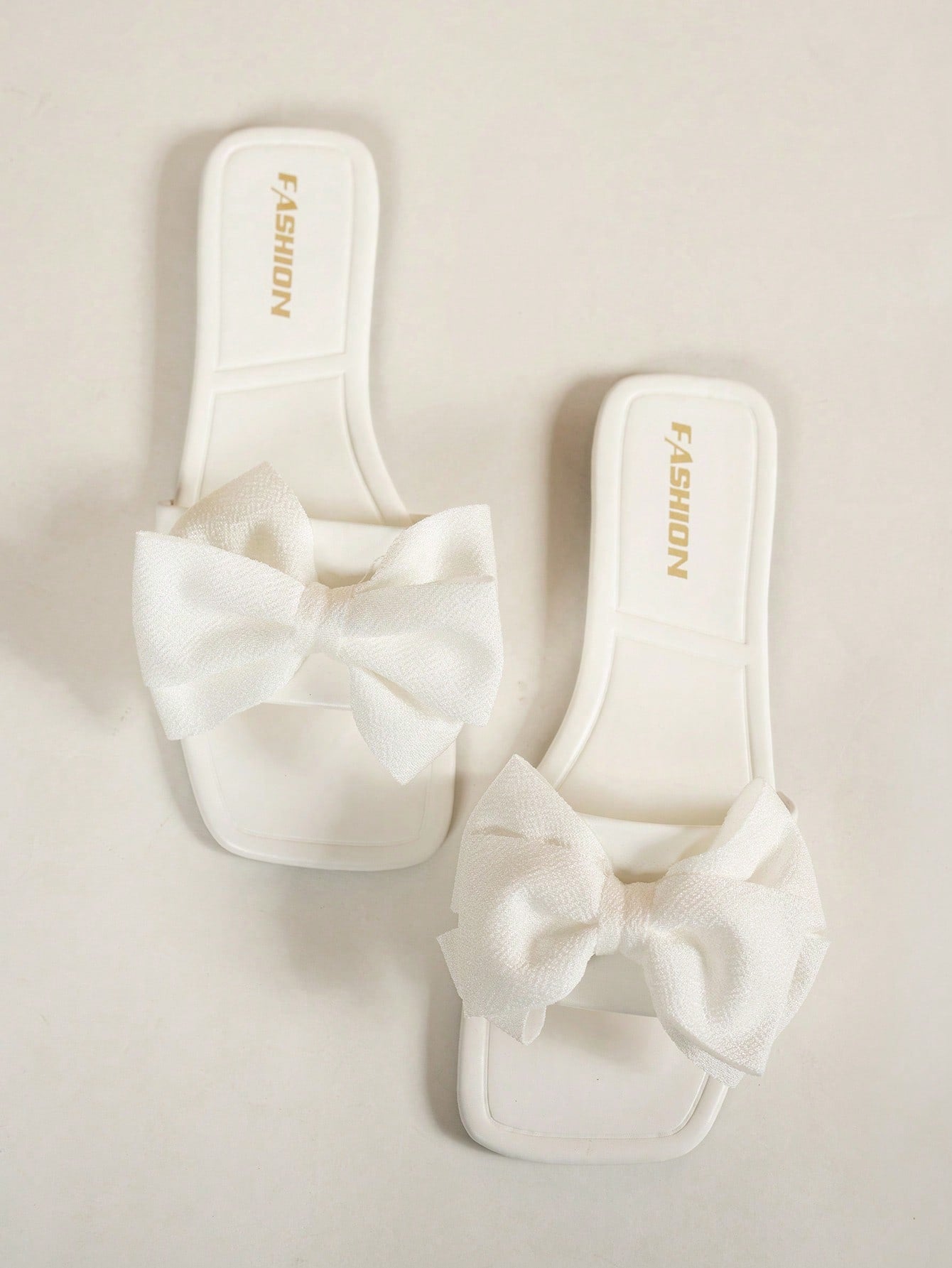 Women's flat slide sandals with a square open toe, geometric detail, and PU leather construction with rubber outsole.
