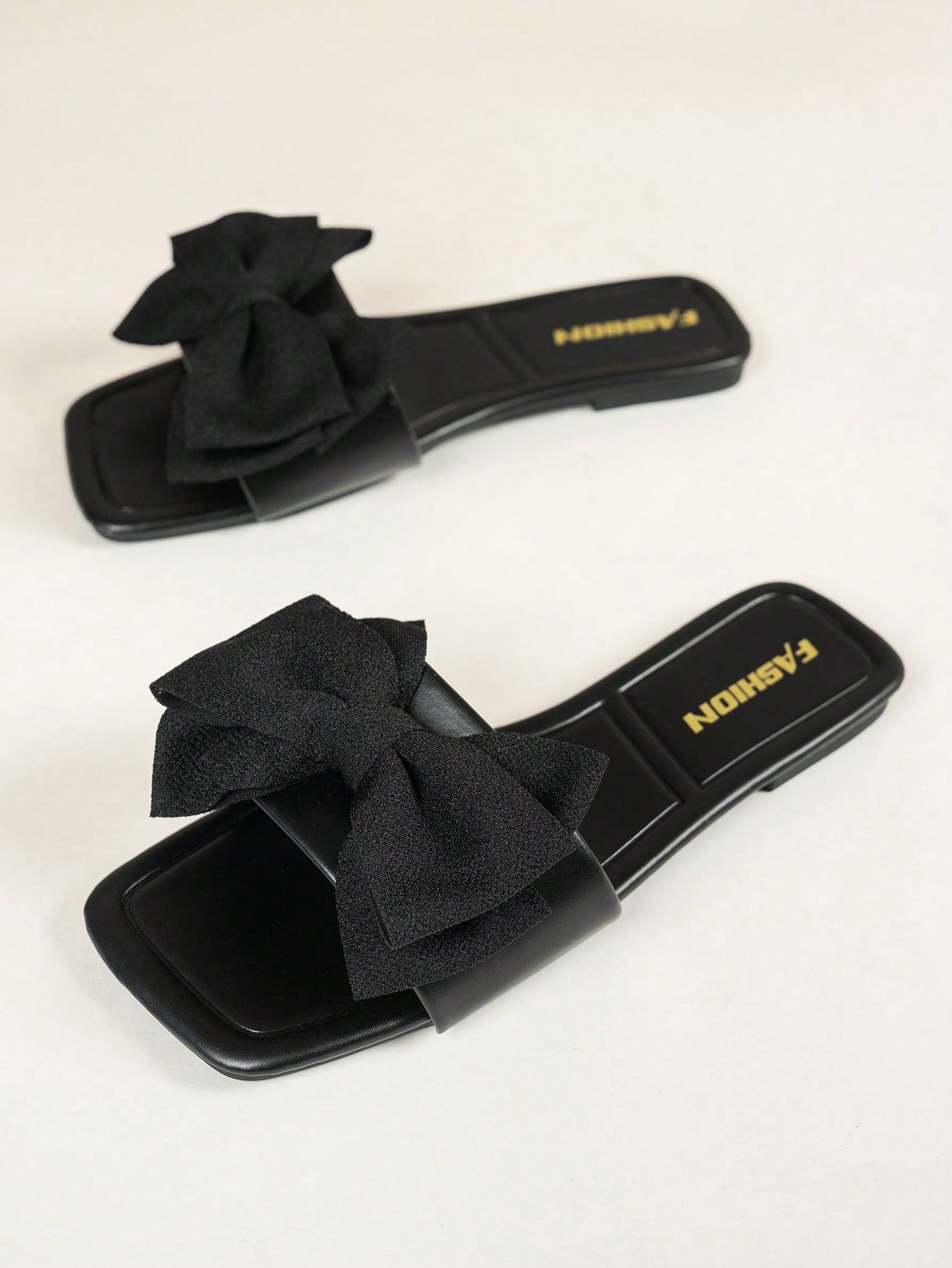 Women's flat slide sandals with a square open toe, geometric detail, and PU leather construction with rubber outsole.
