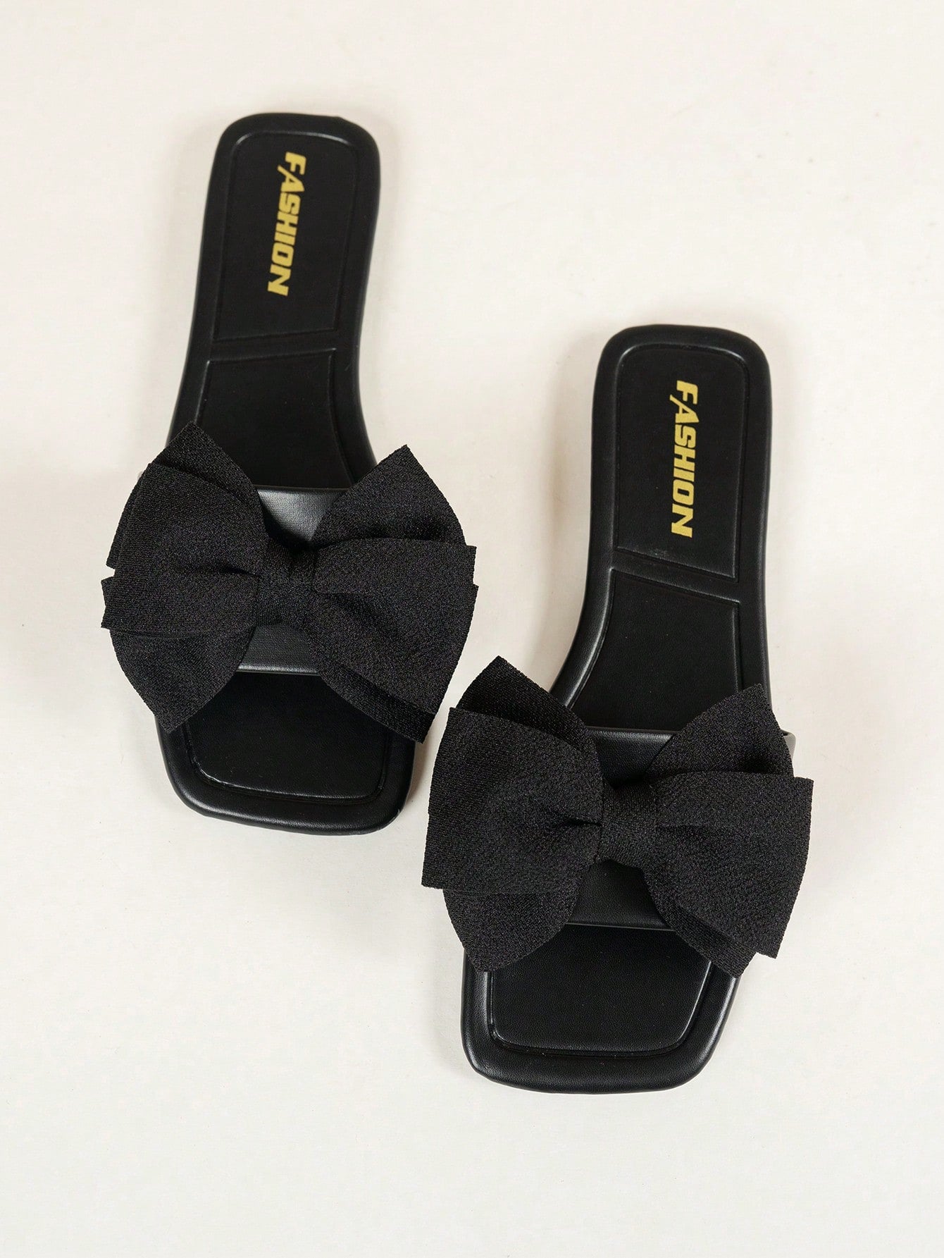 Women's flat slide sandals with a square open toe, geometric detail, and PU leather construction with rubber outsole.