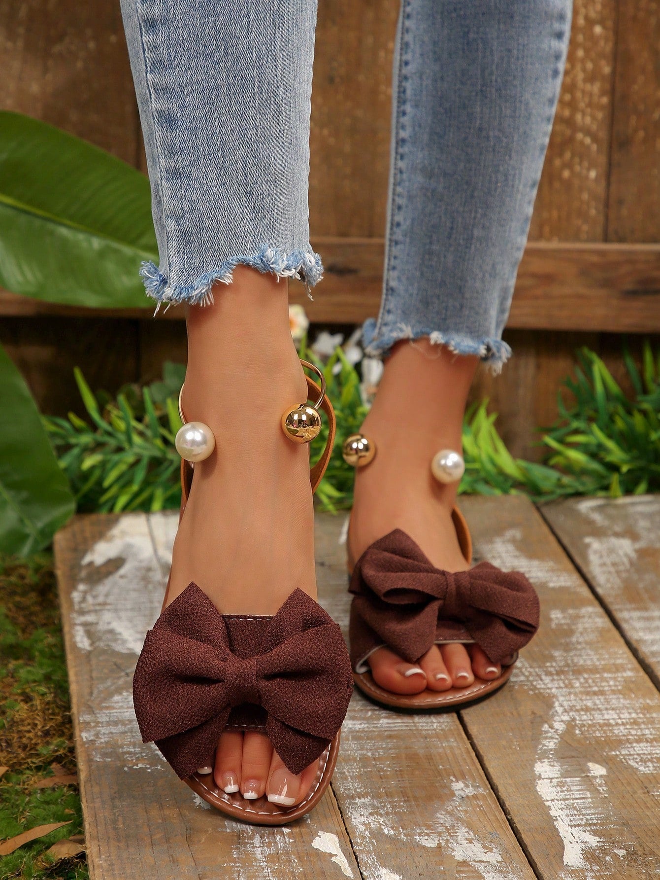 Women’s flat open-toe sandals with faux pearl decor and ankle strap design, featuring a microfiber leather upper and beach-ready fashion style.
