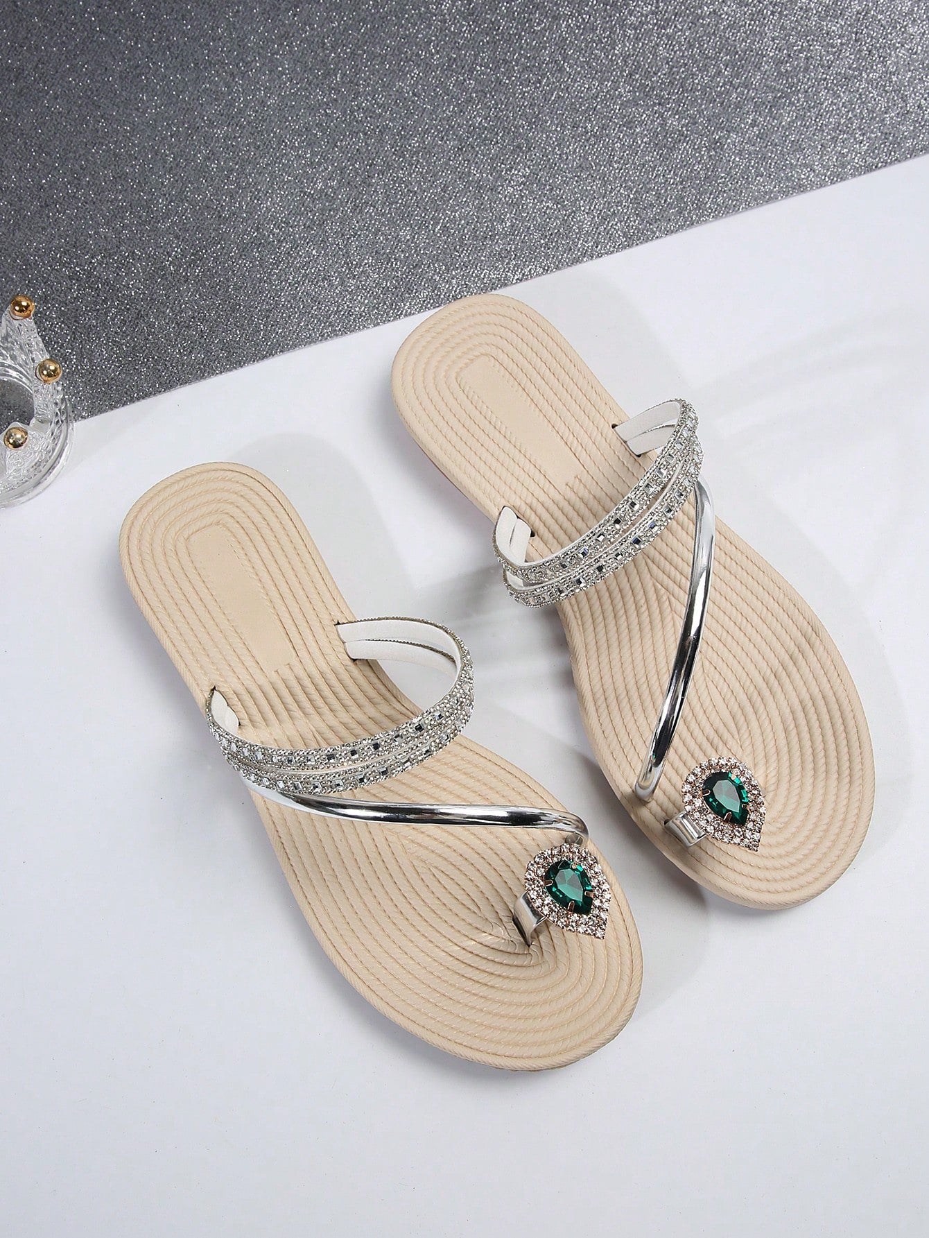 Women's flat slide sandals with crystal-style rhinestone and bow embellishments, toe post front, and beach-ready slip-on design.