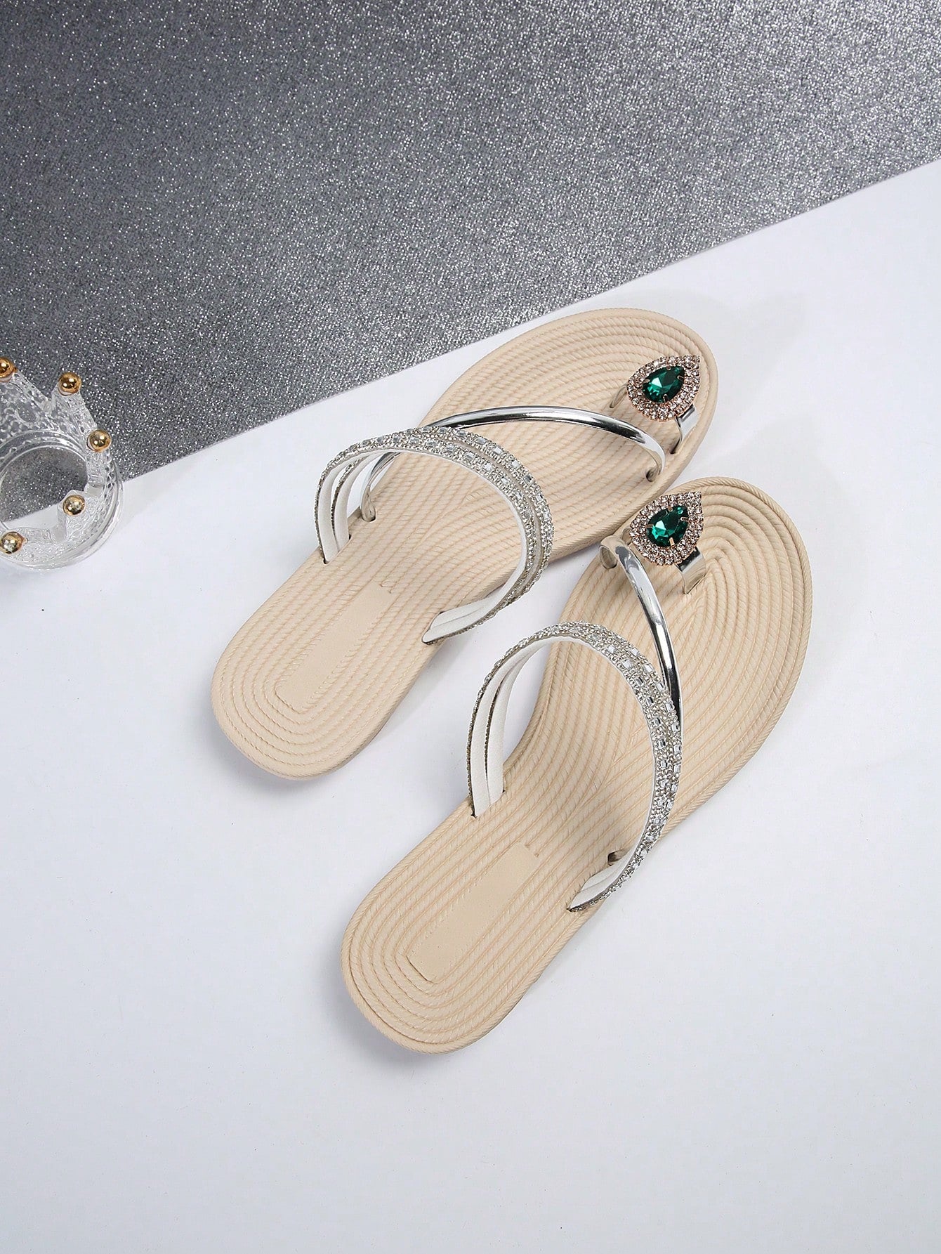 Women's flat slide sandals with crystal-style rhinestone and bow embellishments, toe post front, and beach-ready slip-on design.