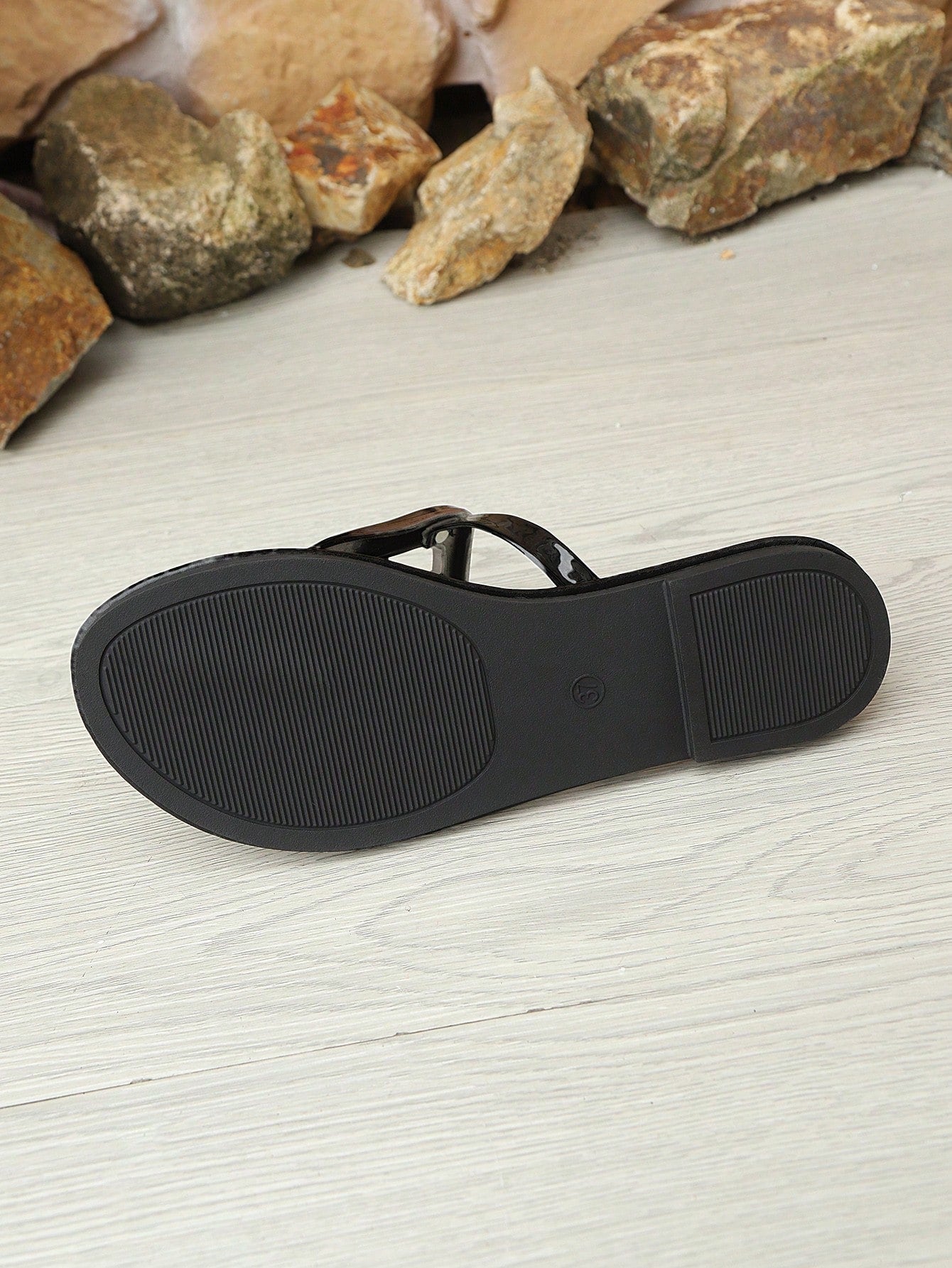Women’s gold flat slide sandals with open toe post design and metal buckle detail, shown as fashionable outdoor summer footwear.