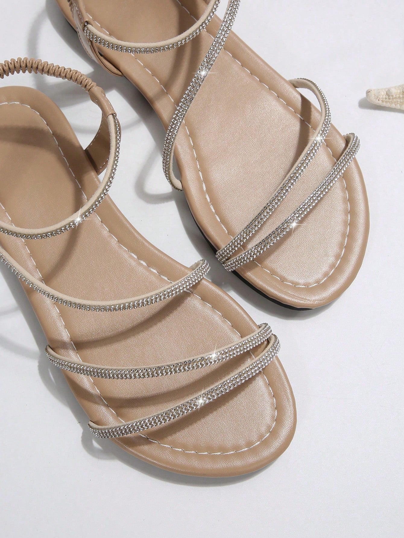 Women's flat sandals with rhinestone strap detail, elastic back, and open round toe in slide style for outdoor or beach wear.