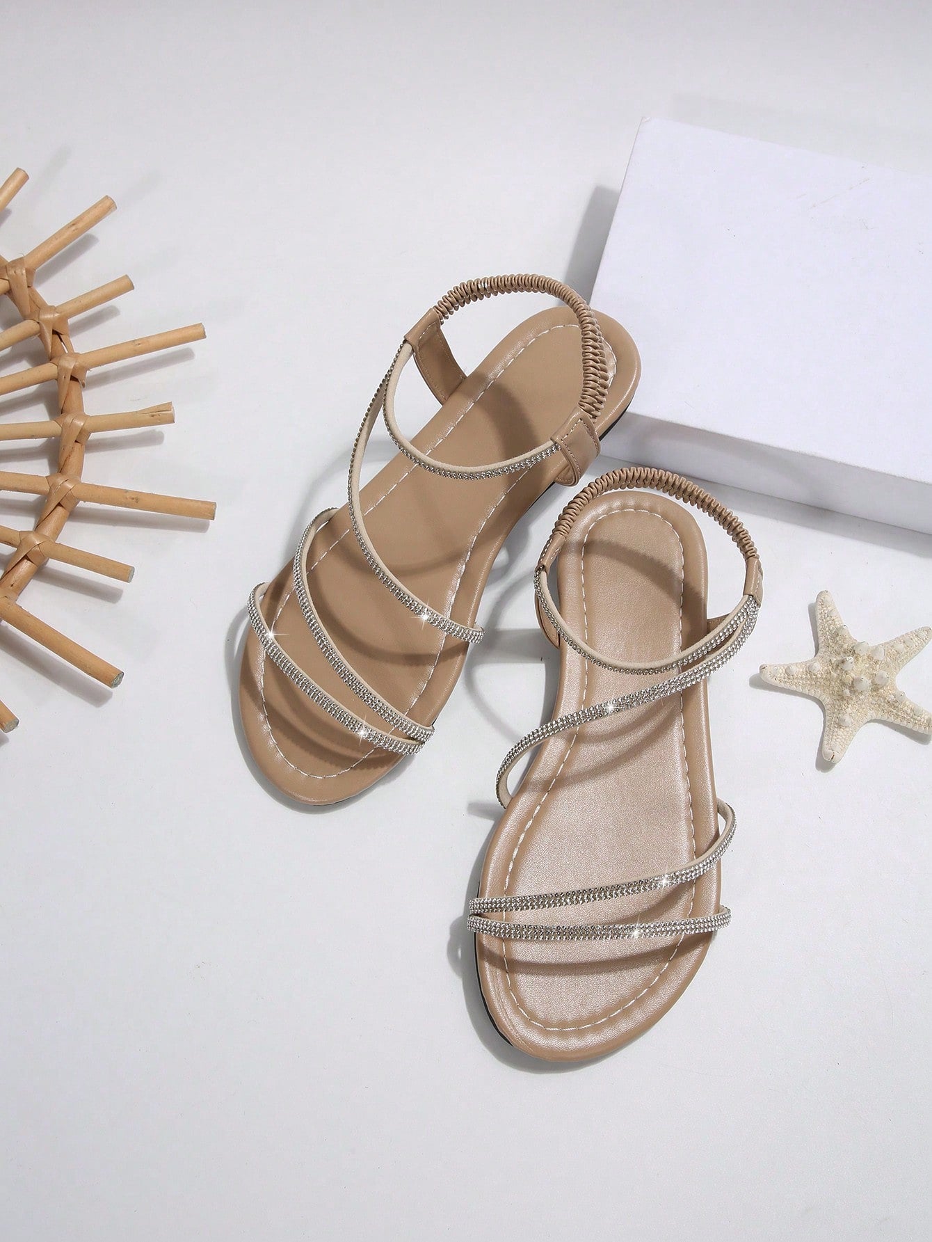 Women's flat sandals with rhinestone strap detail, elastic back, and open round toe in slide style for outdoor or beach wear.