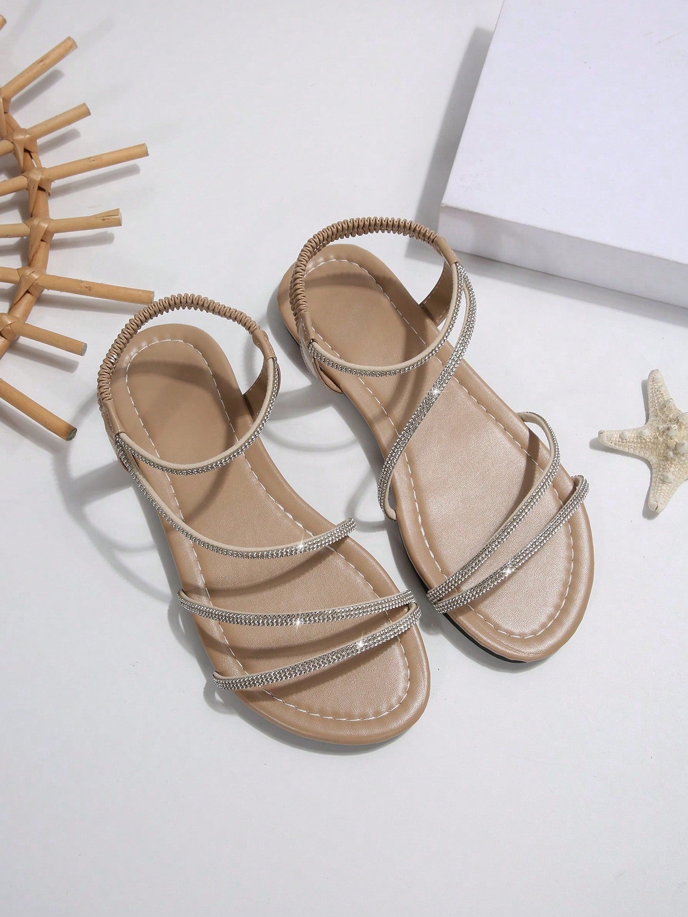 Women's flat sandals with rhinestone strap detail, elastic back, and open round toe in slide style for outdoor or beach wear.