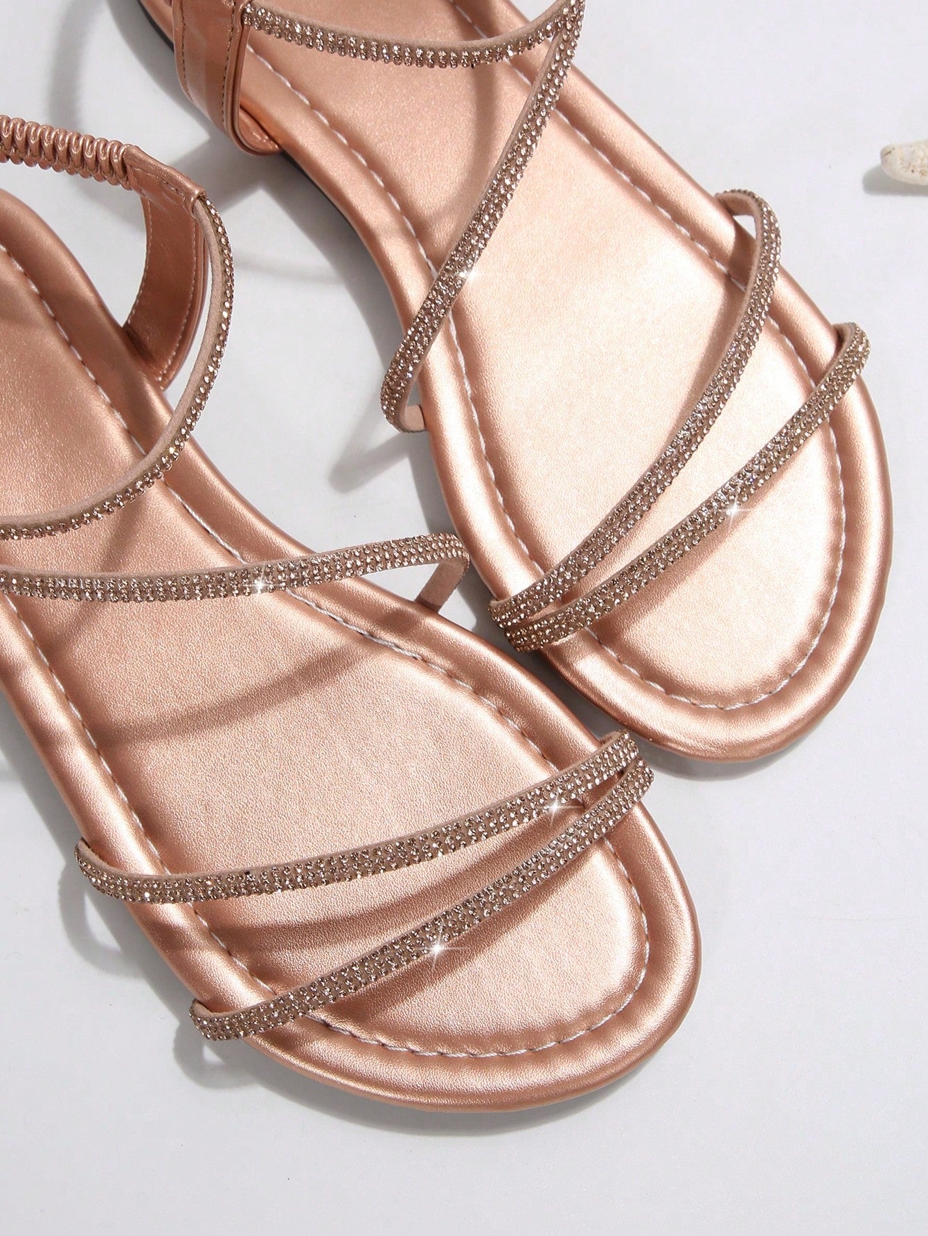 Women's flat sandals with rhinestone strap detail, elastic back, and open round toe in slide style for outdoor or beach wear.
