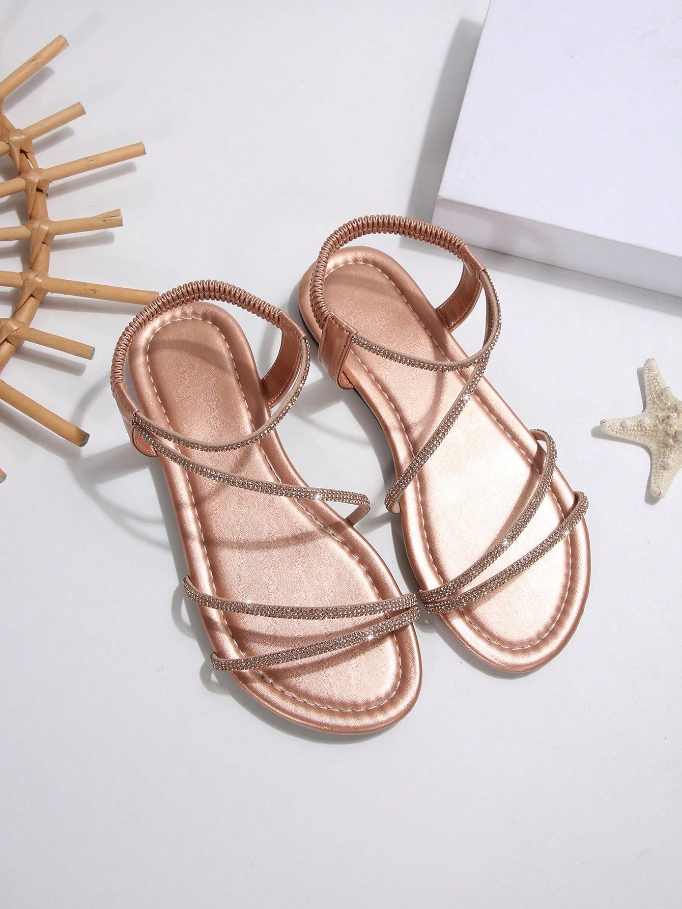 Women's flat sandals with rhinestone strap detail, elastic back, and open round toe in slide style for outdoor or beach wear.