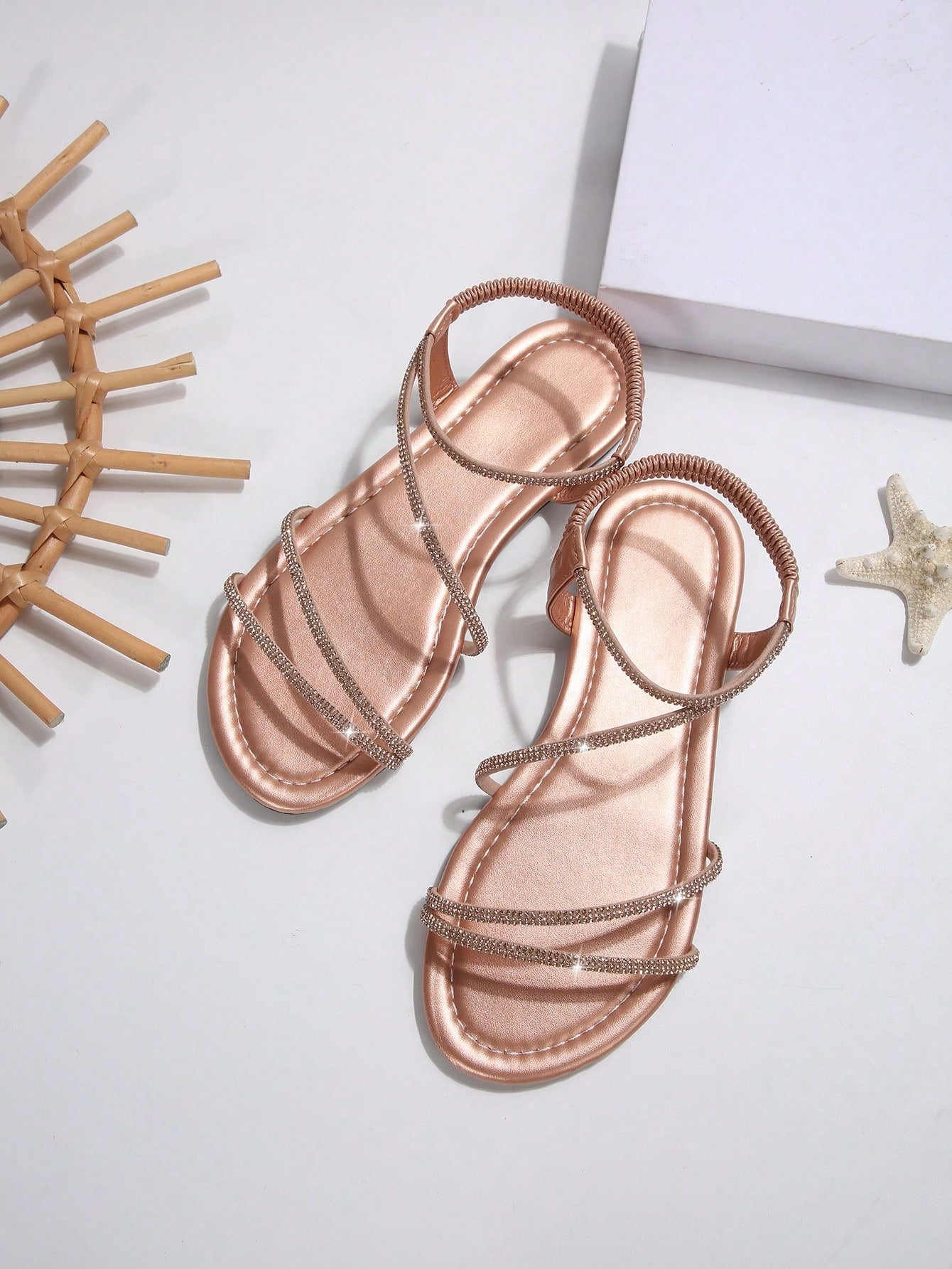 Women's flat sandals with rhinestone strap detail, elastic back, and open round toe in slide style for outdoor or beach wear.