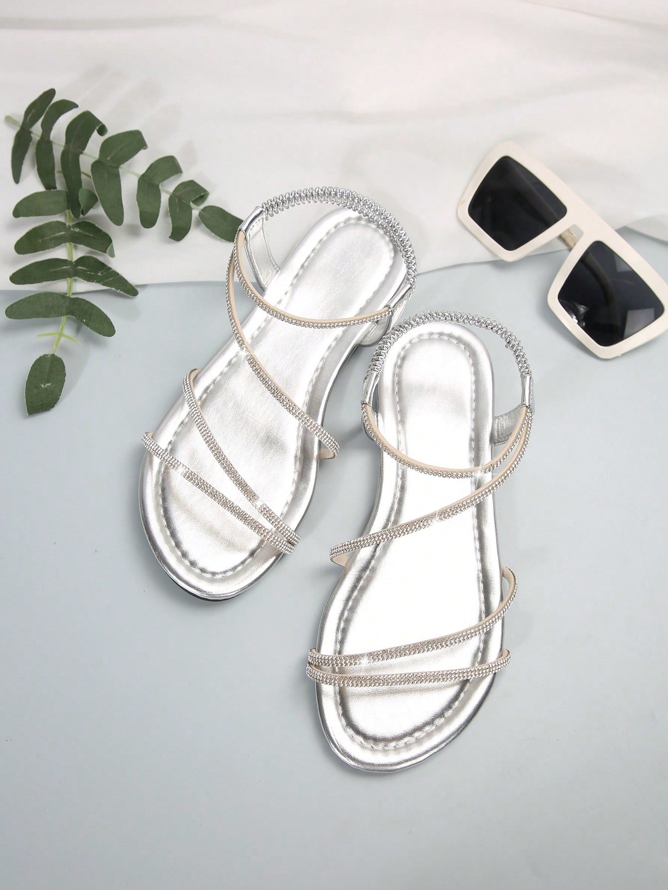 Women's flat sandals with rhinestone strap detail, elastic back, and open round toe in slide style for outdoor or beach wear.