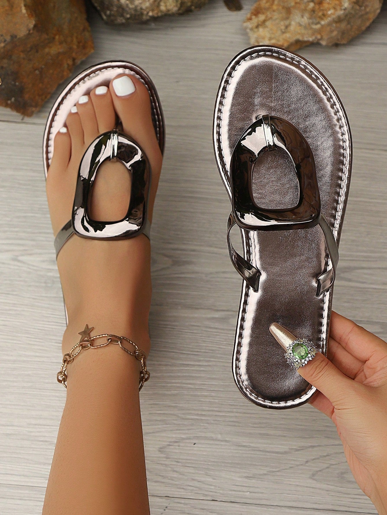 Women’s gold flat slide sandals with open toe post design and metal buckle detail, shown as fashionable outdoor summer footwear.