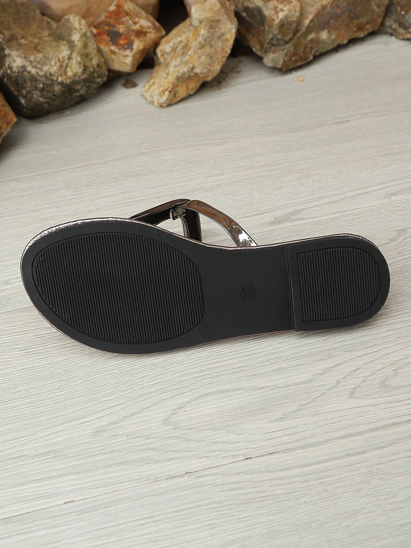 Women’s gold flat slide sandals with open toe post design and metal buckle detail, shown as fashionable outdoor summer footwear.