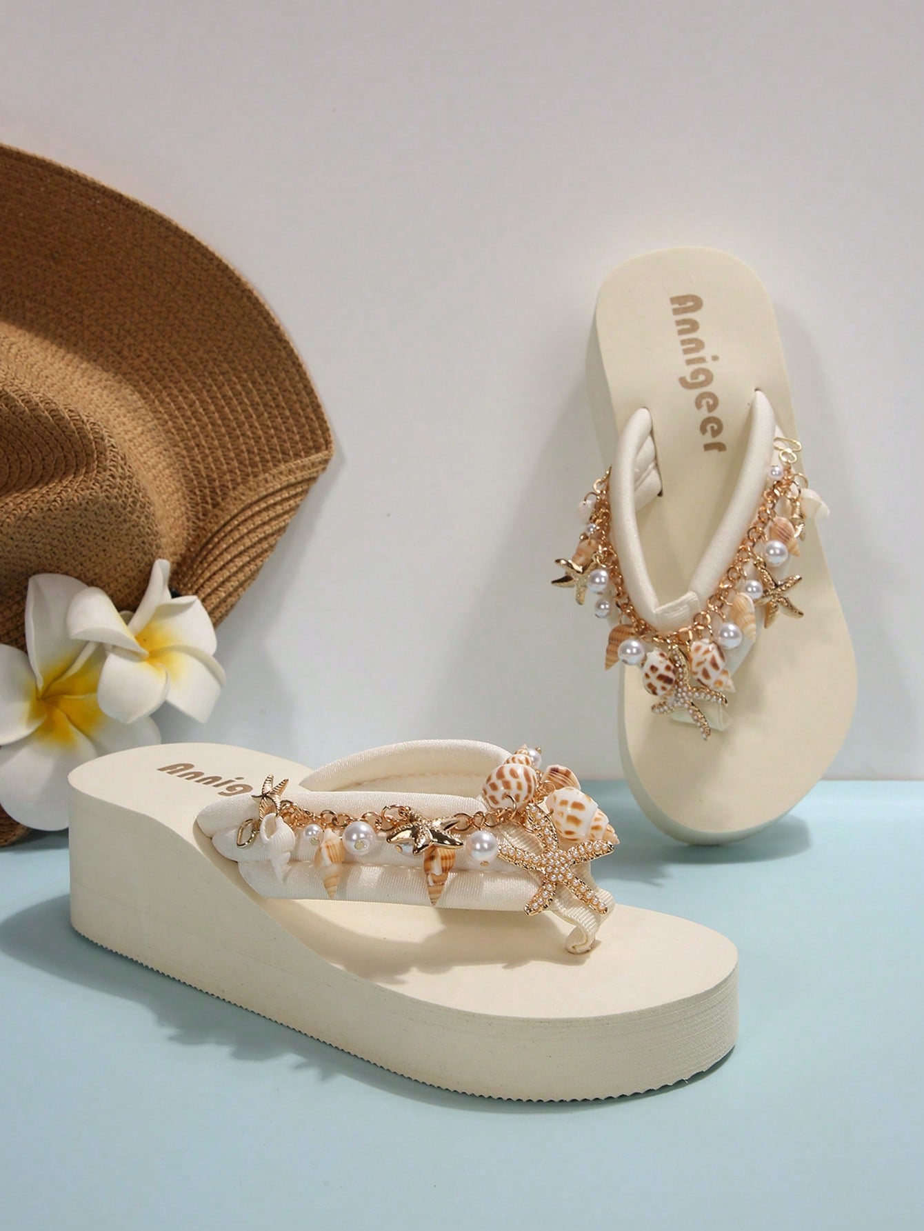 Beige women’s platform wedge slip-on sandals with toe post, shell chain decor, and flower rhinestone details, designed in a beach holiday flip-flop style.