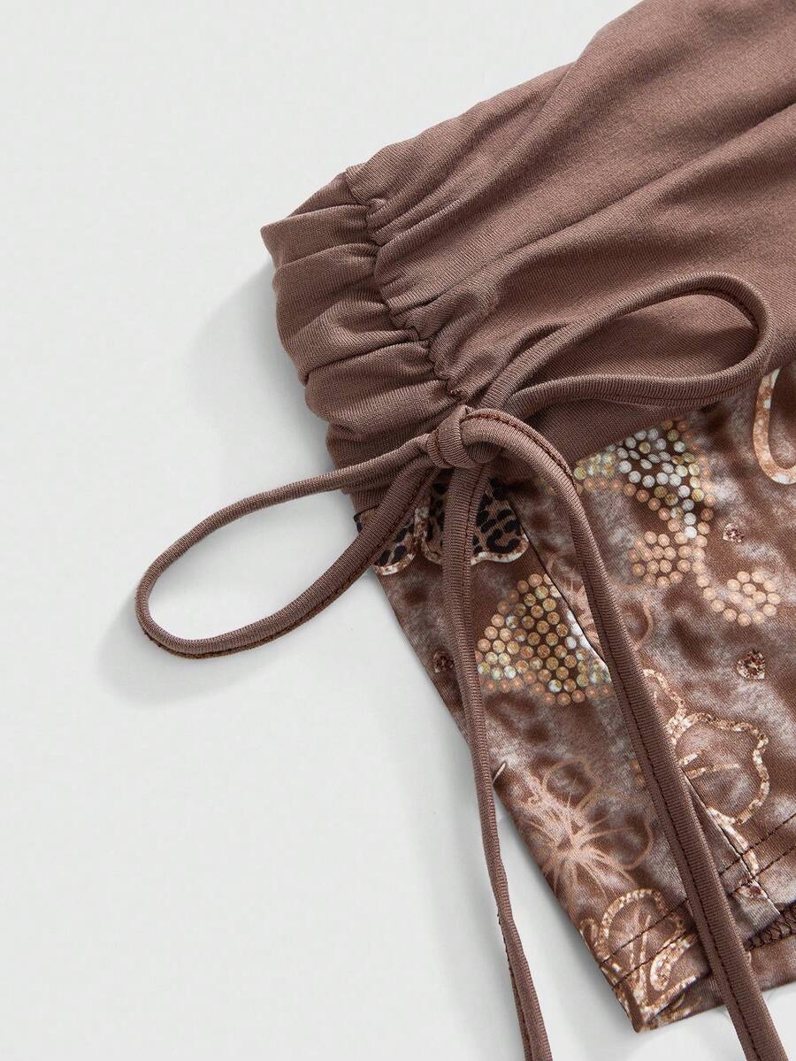 Women's low waist mini track shorts with elastic waistband, drawstring knot, ruched details, and plant pattern in a Y2K boho style