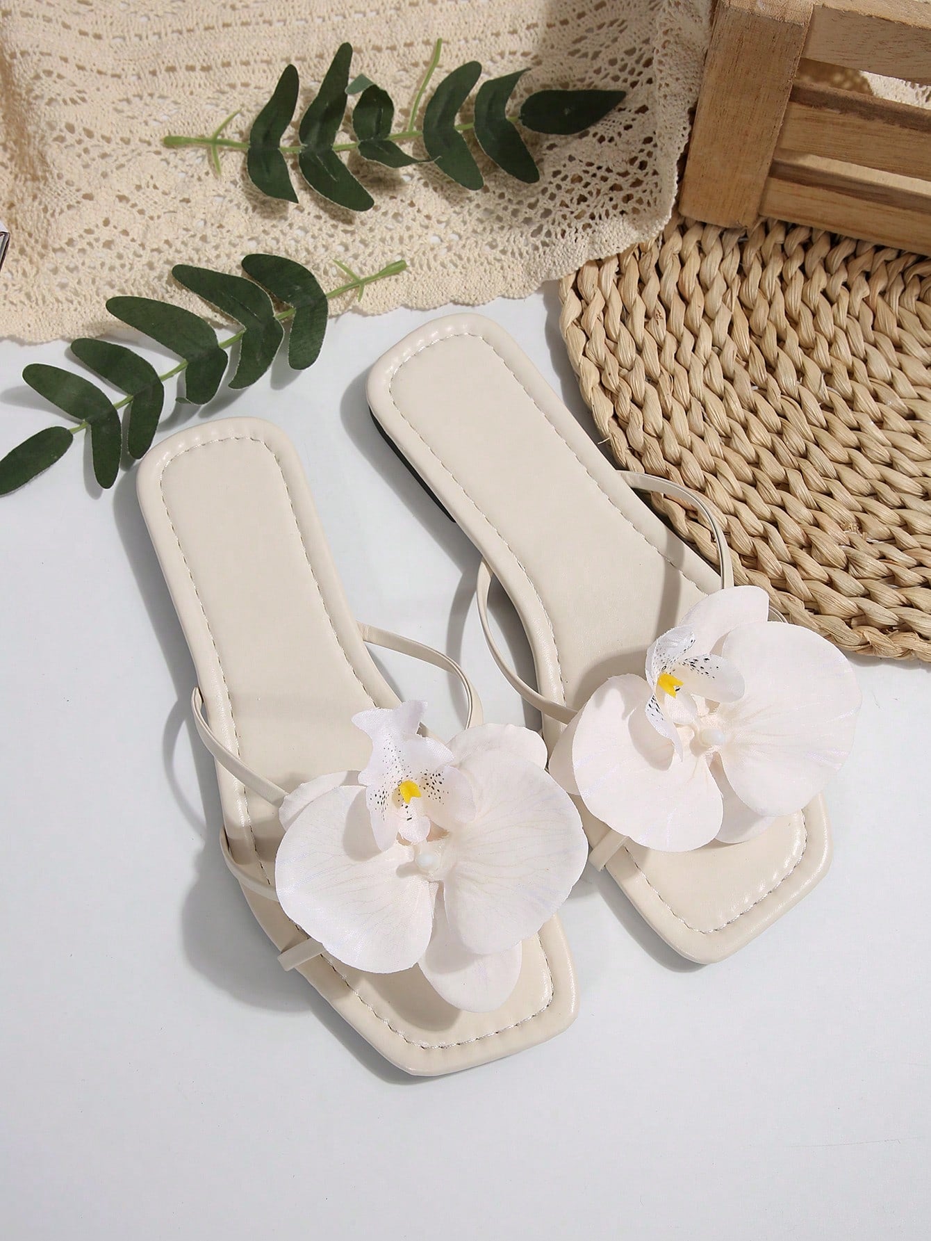 Wide fit women's beige flat thong sandals with butterfly orchid appliqué decor and open toe, suitable for beach, vacation, home, and casual everyday wear.