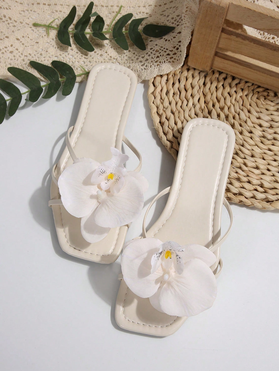 Wide fit women's beige flat thong sandals with butterfly orchid appliqué decor and open toe, suitable for beach, vacation, home, and casual everyday wear.