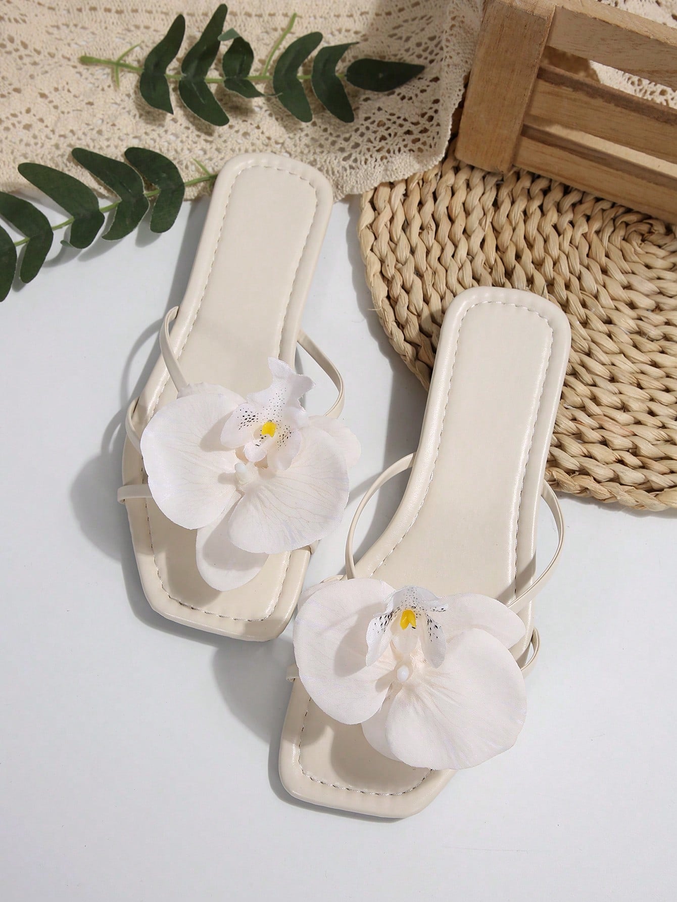 Wide fit women's beige flat thong sandals with butterfly orchid appliqué decor and open toe, suitable for beach, vacation, home, and casual everyday wear.