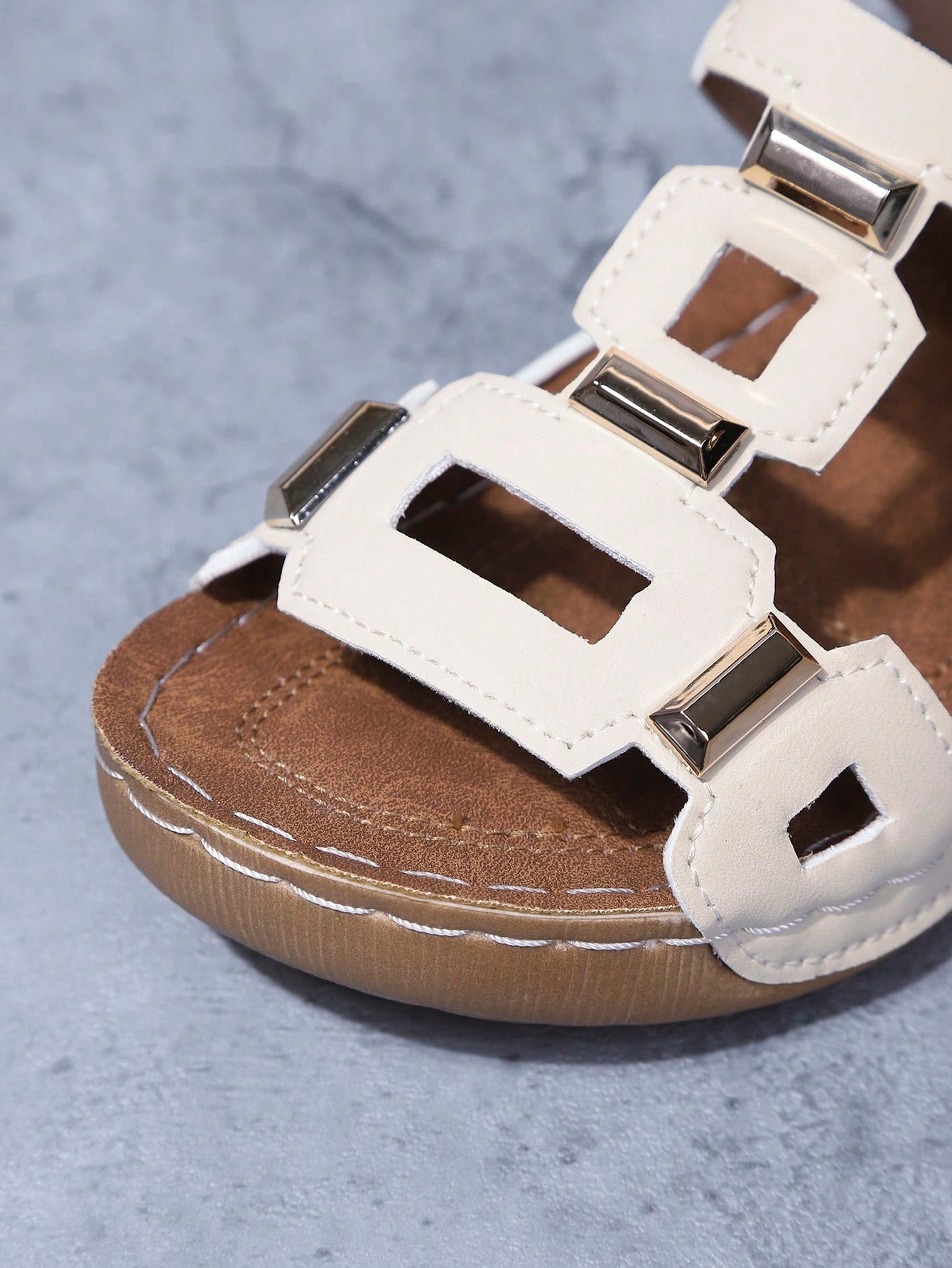 Women's open-toe wedge slide sandals with studded hollow-out upper, cross-over straps, buckle closure, and thick soft sole