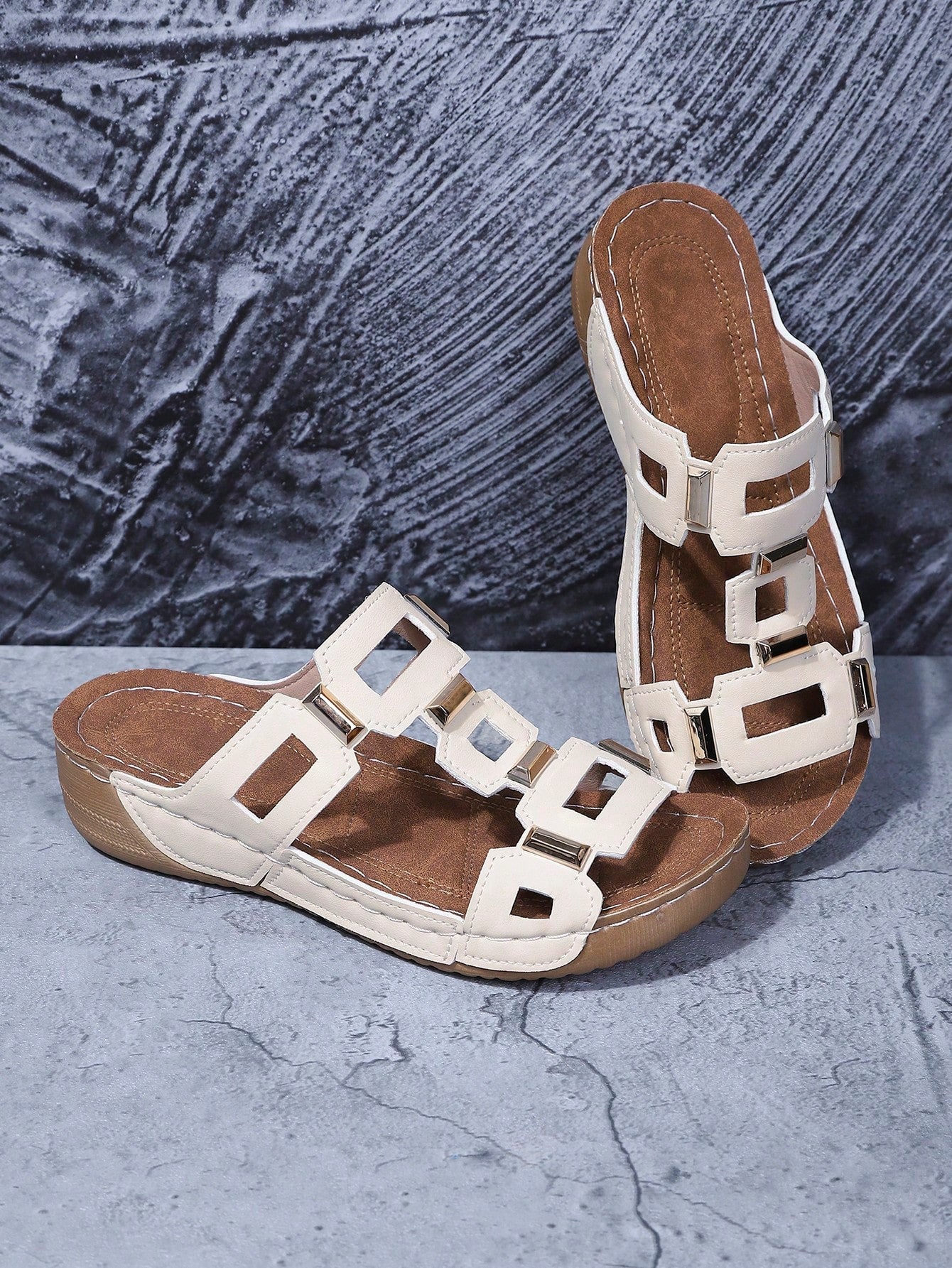 Women's open-toe wedge slide sandals with studded hollow-out upper, cross-over straps, buckle closure, and thick soft sole