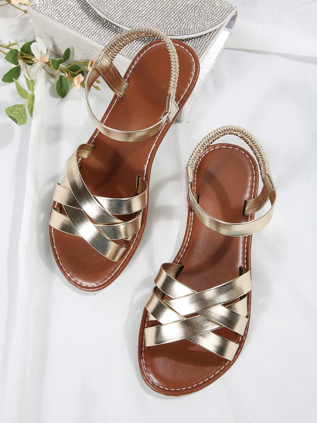 Women’s flat slide sandals with criss-cross straps, open toe, and braid detail, designed for lightweight casual and beach wear.