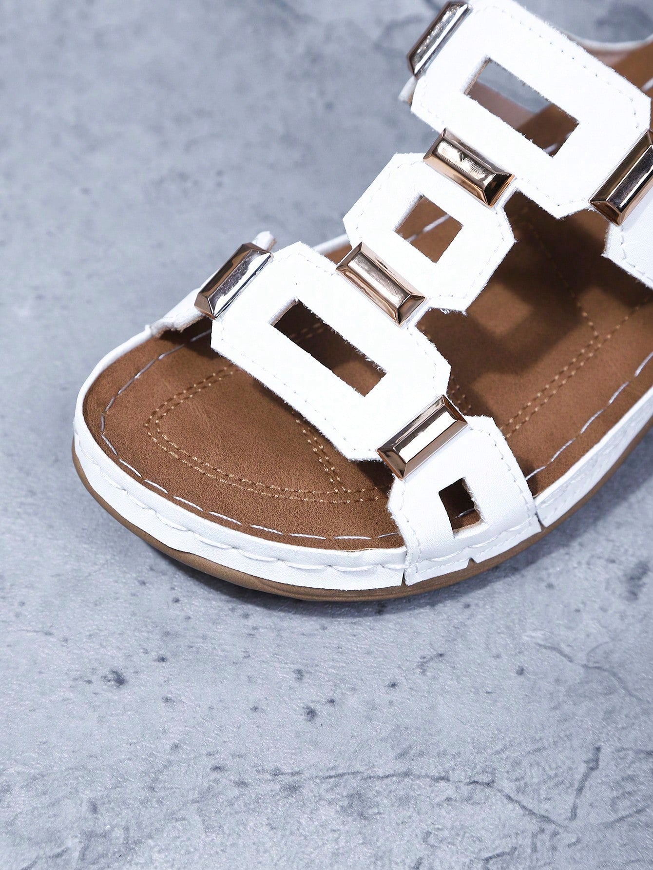 Women's open-toe wedge slide sandals with studded hollow-out upper, cross-over straps, buckle closure, and thick soft sole