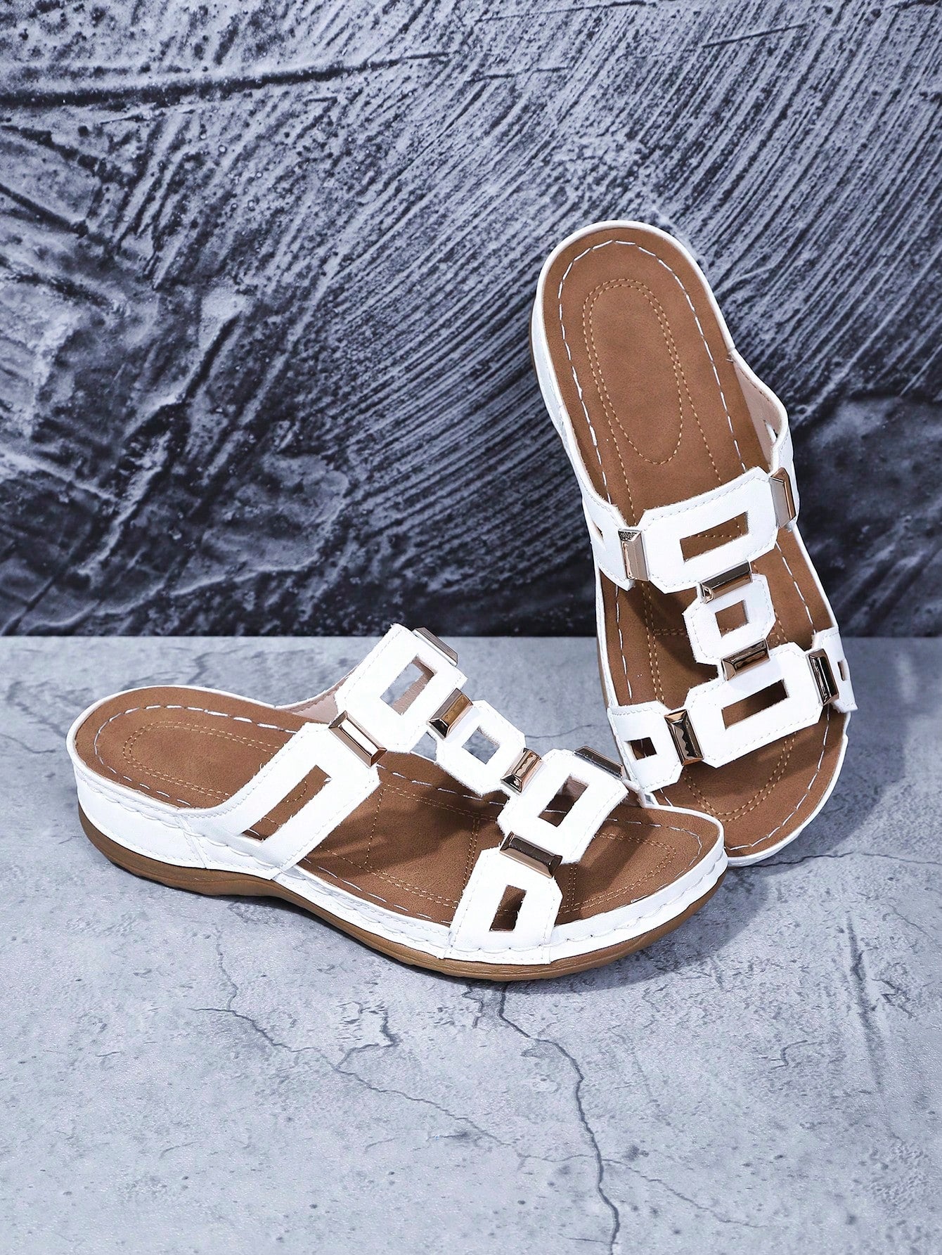 Women's open-toe wedge slide sandals with studded hollow-out upper, cross-over straps, buckle closure, and thick soft sole