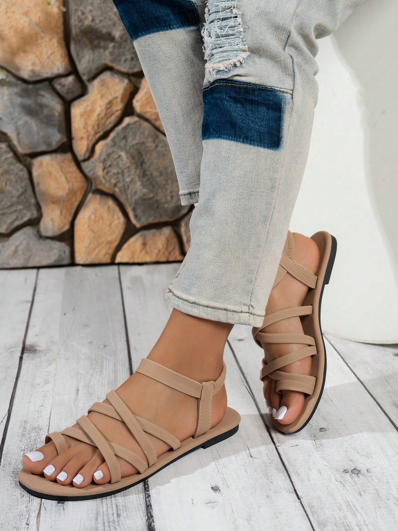 Women's flat sandals featuring a solid-color design with criss-cross braided straps and a toe-post slide style, suitable for beach, vacation, and casual wear.