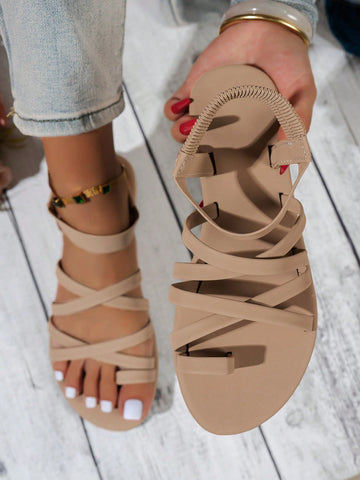 Women's flat sandals featuring a solid-color design with criss-cross braided straps and a toe-post slide style, suitable for beach, vacation, and casual wear.