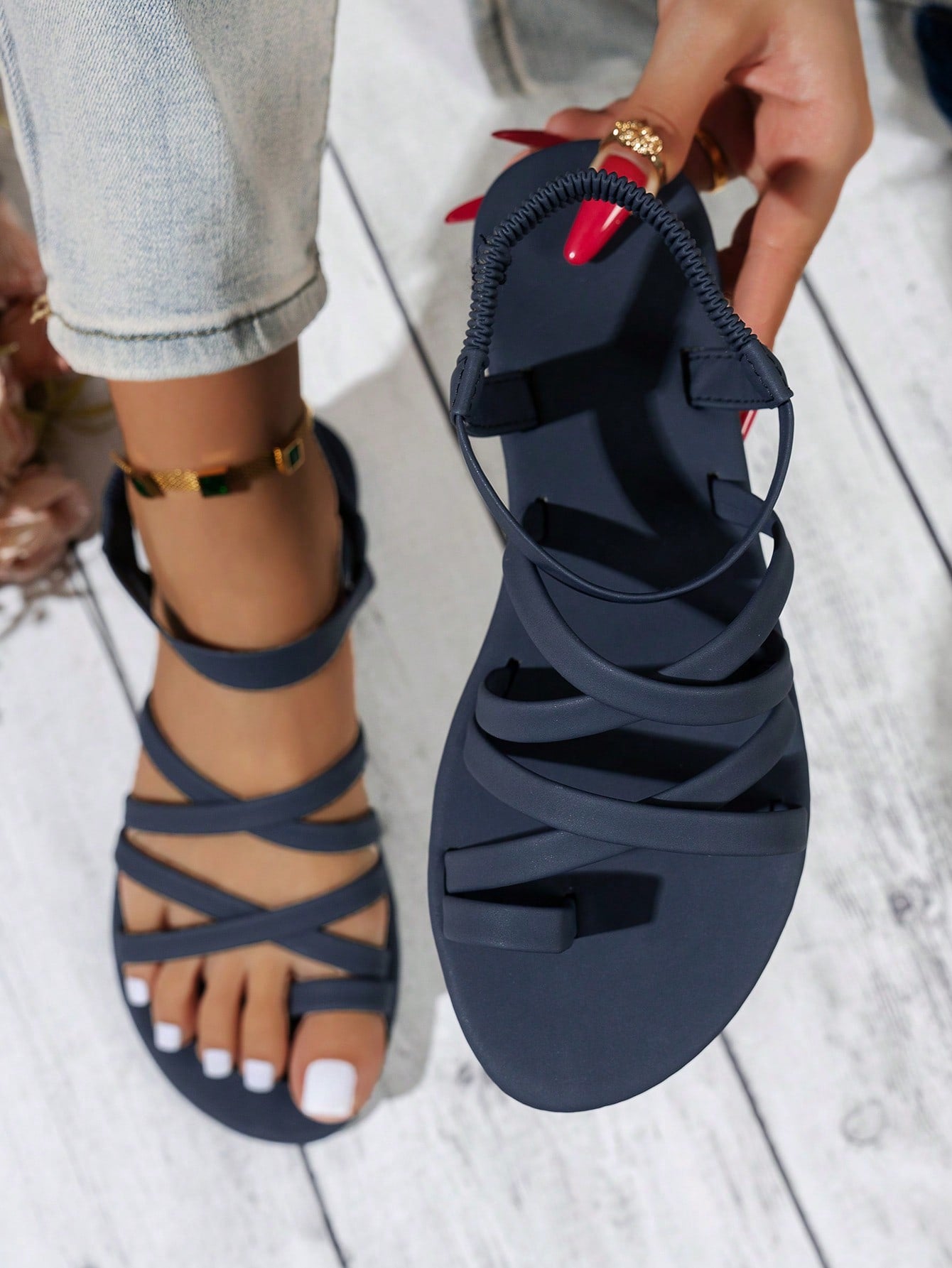 Women's flat sandals featuring a solid-color design with criss-cross braided straps and a toe-post slide style, suitable for beach, vacation, and casual wear.