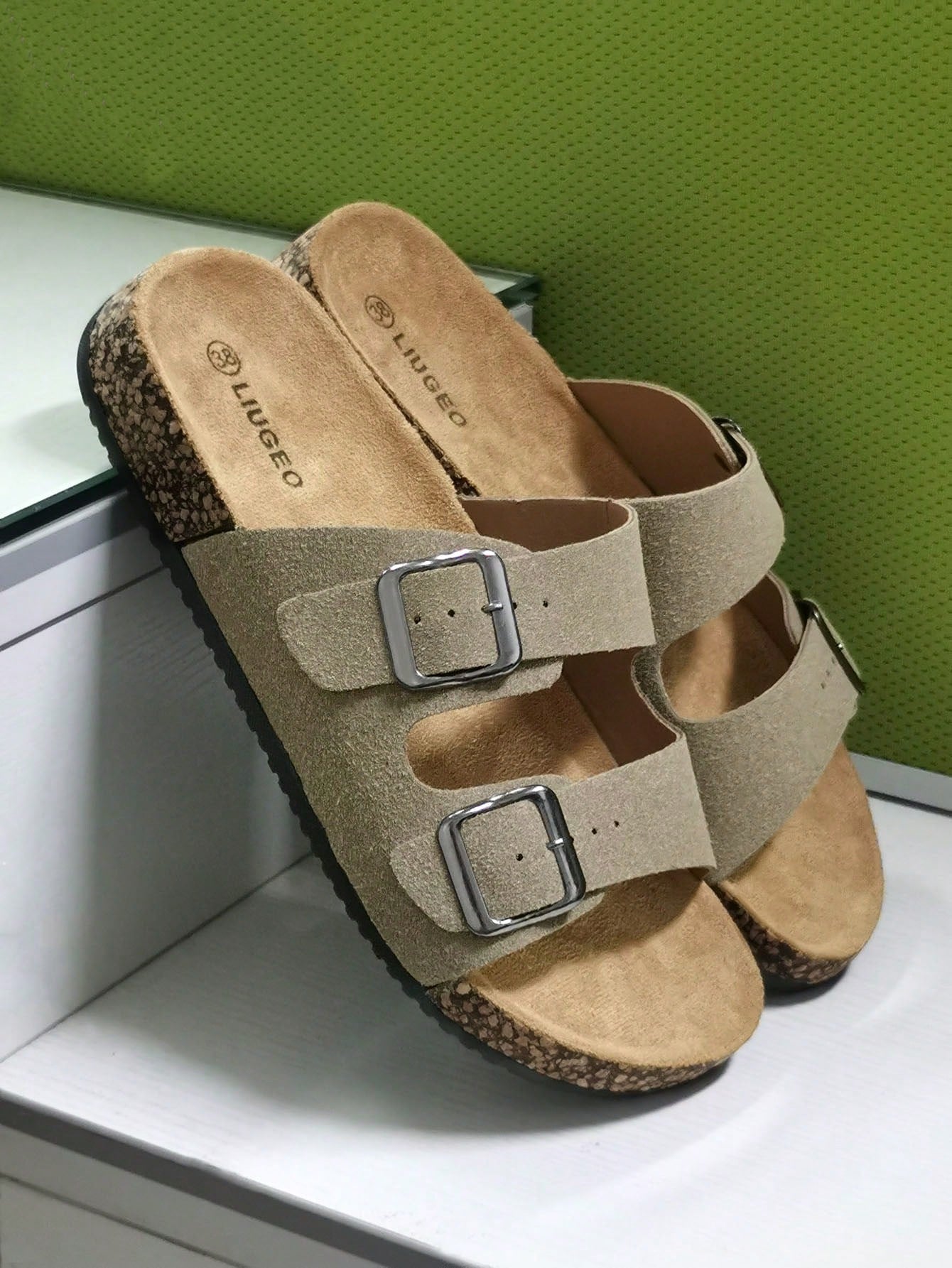 Open-toe footbed slip-on mule sandals with buckle detail and cork-style sole, flat heel design for casual summer home and outdoor walking.