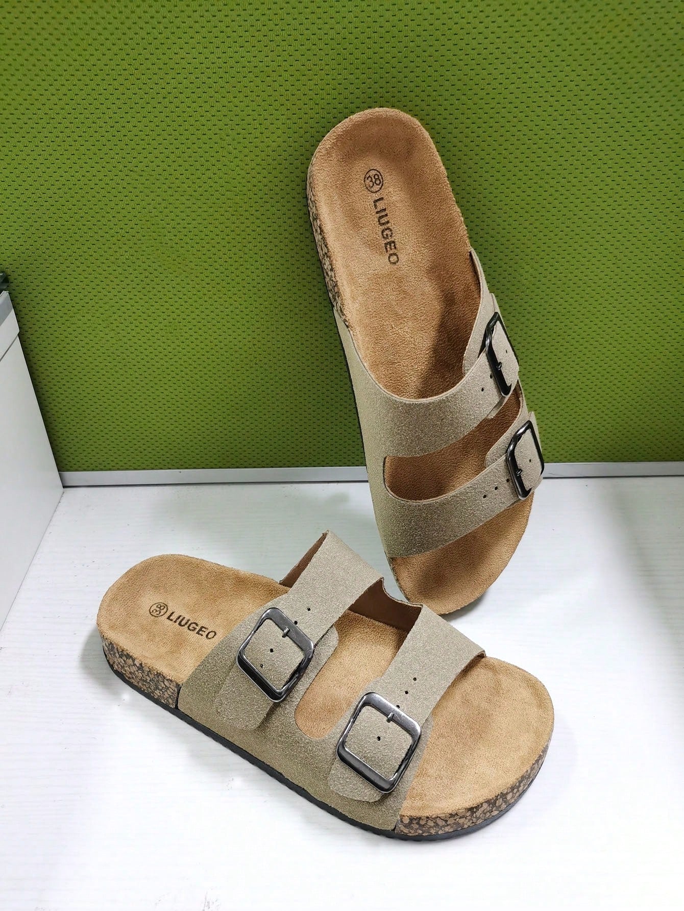 Open-toe footbed slip-on mule sandals with buckle detail and cork-style sole, flat heel design for casual summer home and outdoor walking.