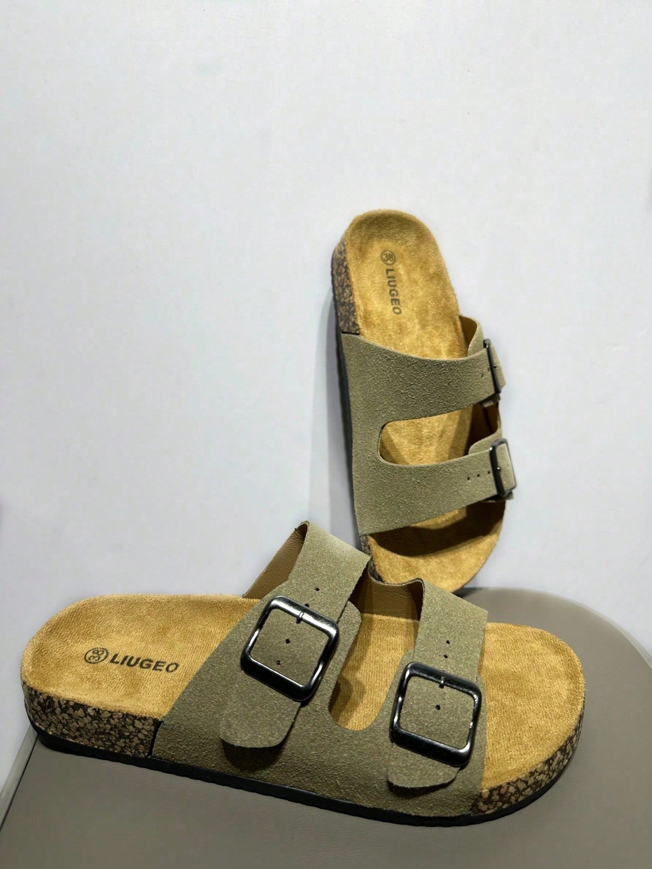 Open-toe footbed slip-on mule sandals with buckle detail and cork-style sole, flat heel design for casual summer home and outdoor walking.