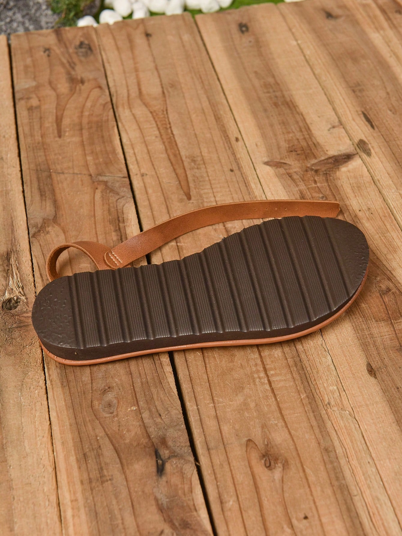 Women's brown flat gladiator sandals with open toe, buckle detail, and loose cross straps, suitable for beach and outdoor casual wear.