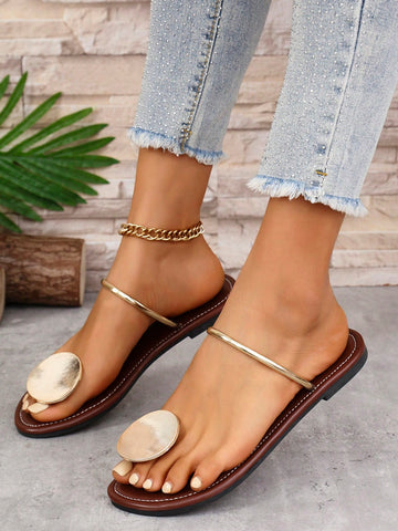 Women’s flat thong sandals with a shiny round buckle, high-gloss finish, semi-circle strap, and toe post design