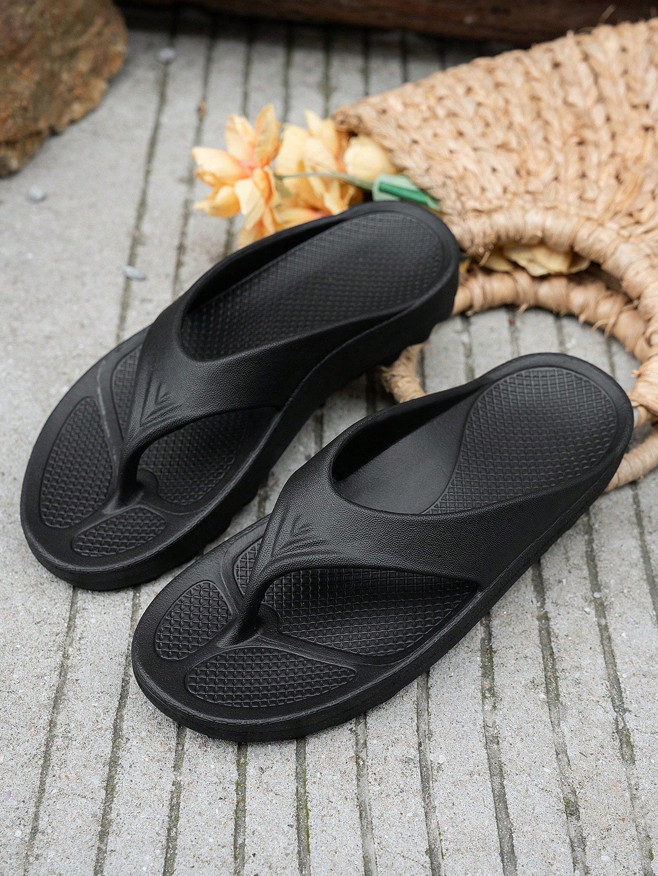 Women's solid color flip flops with open-toe design, flat sole, and cut-out details, suitable for casual indoor or outdoor wear at the beach or pool.