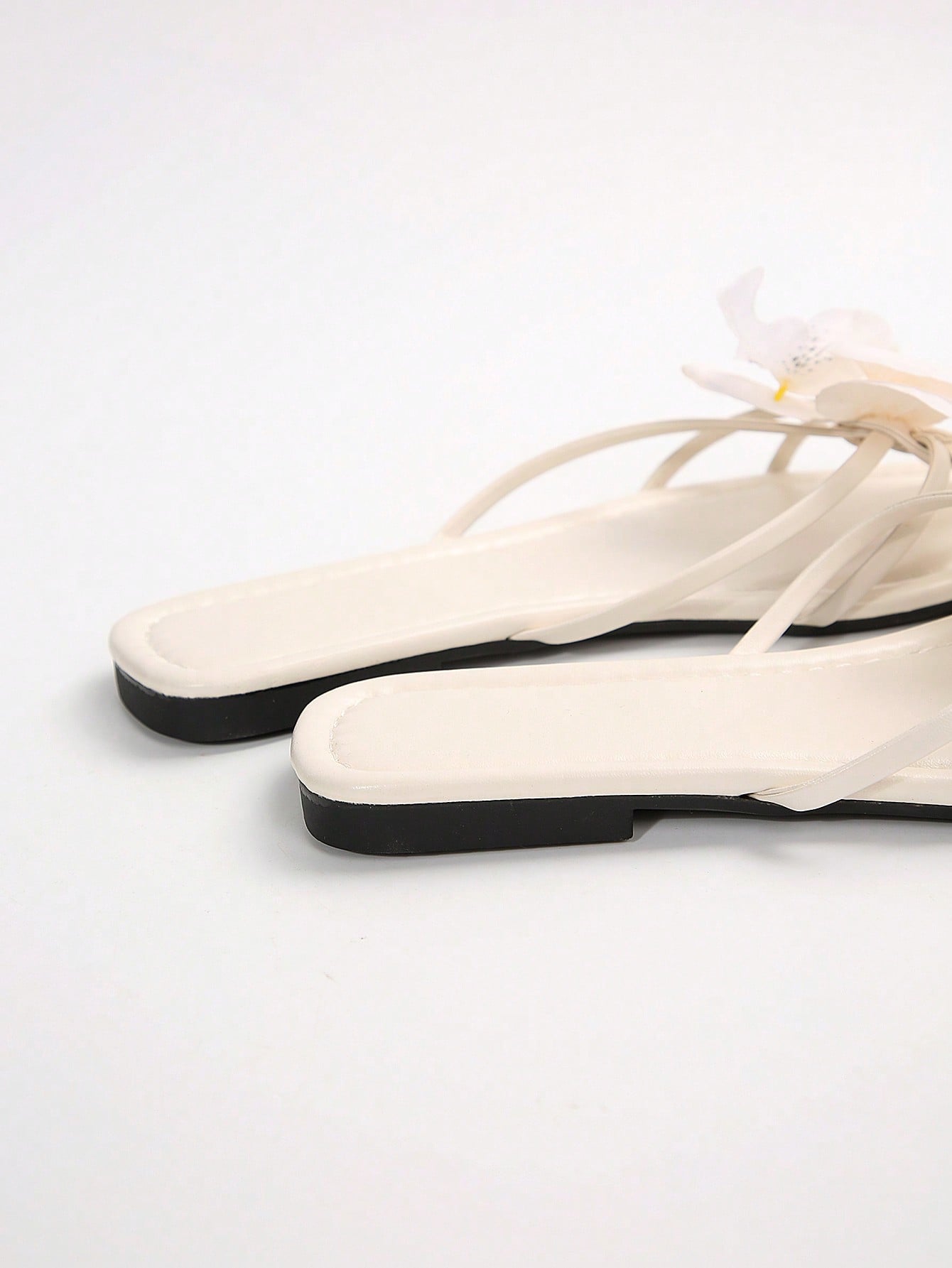 Wide fit women's beige flat thong sandals with butterfly orchid appliqué decor and open toe, suitable for beach, vacation, home, and casual everyday wear.