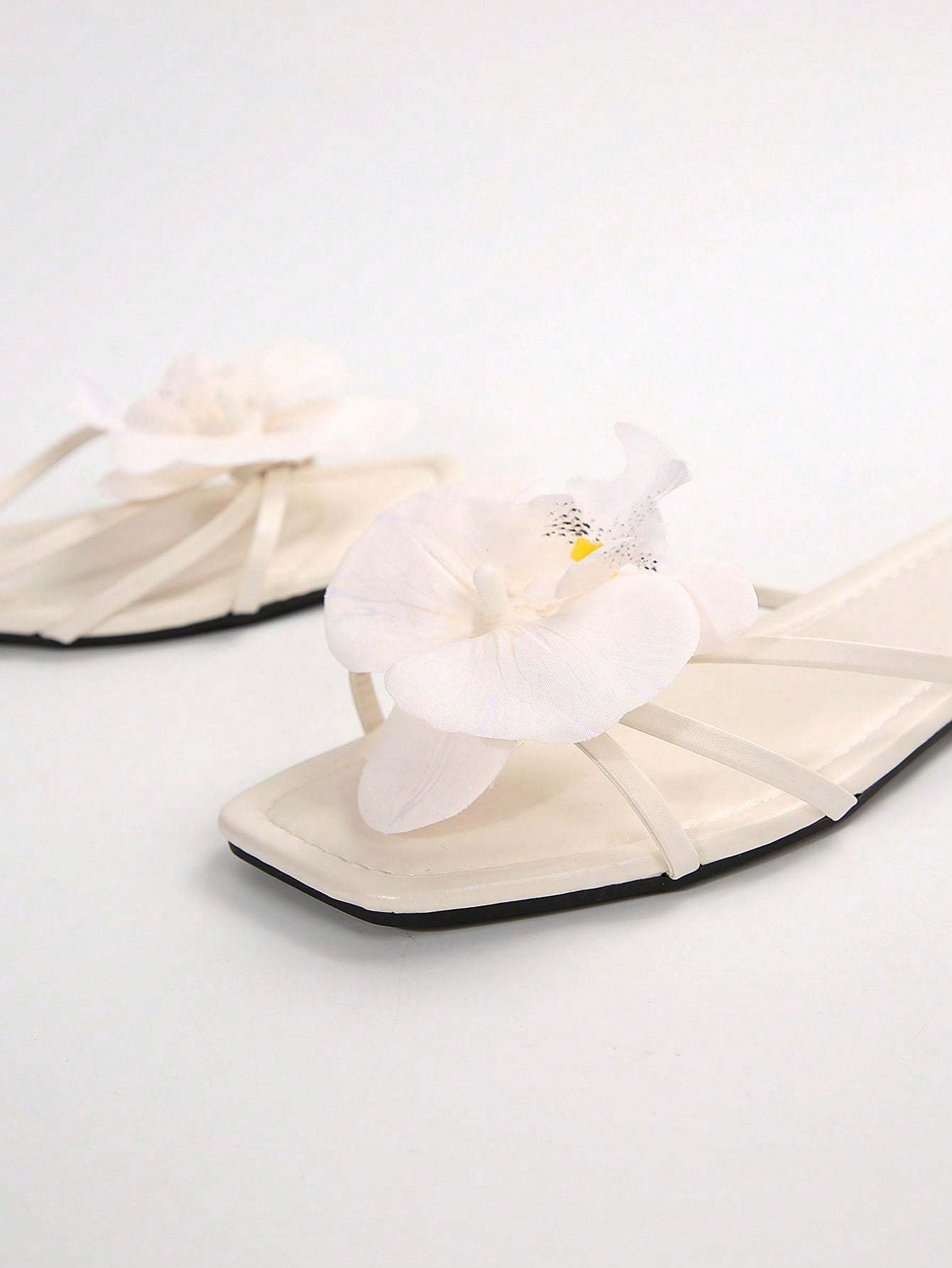 Wide fit women's beige flat thong sandals with butterfly orchid appliqué decor and open toe, suitable for beach, vacation, home, and casual everyday wear.