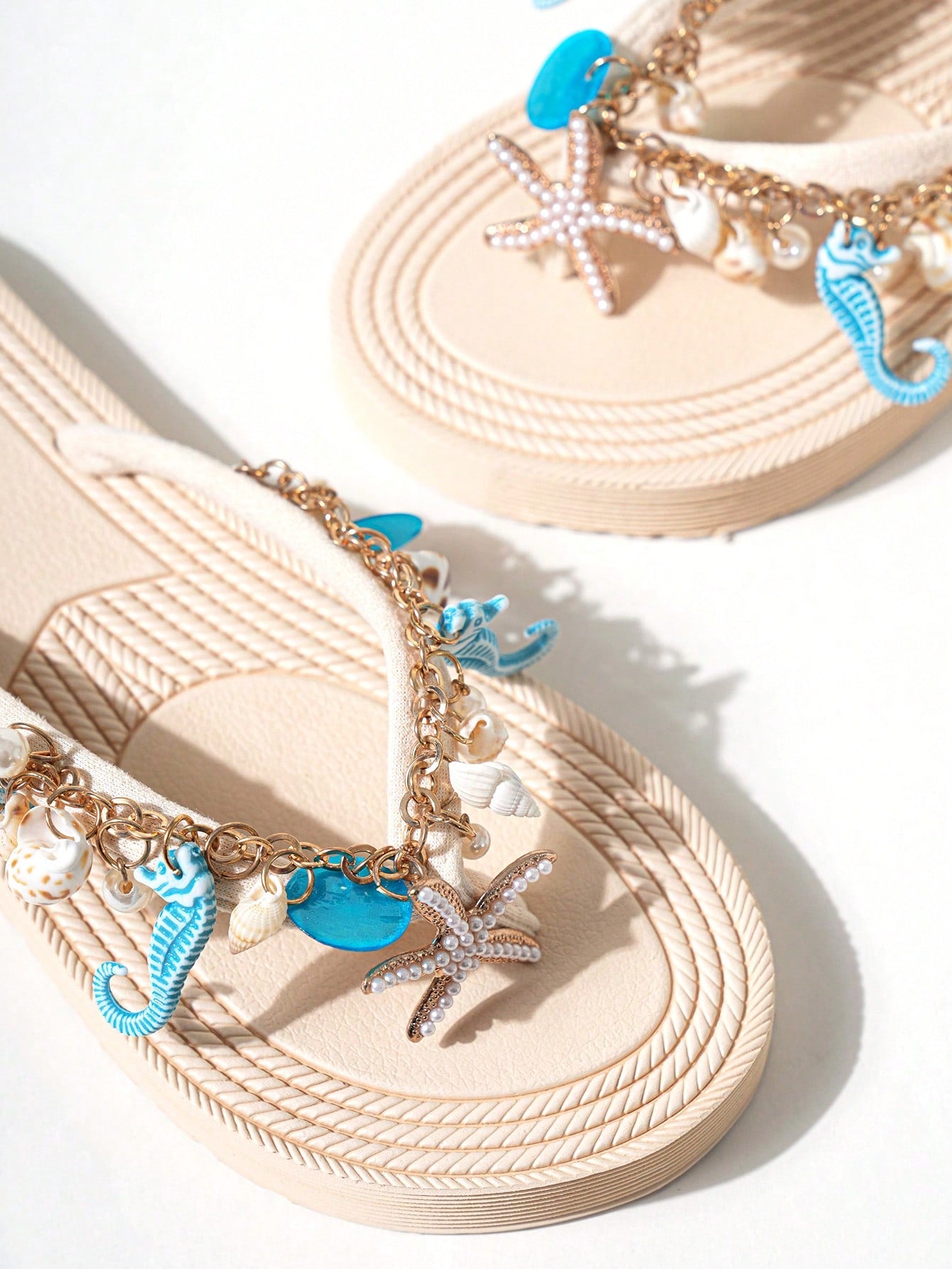Handmade women’s beach flip flop sandals with shell and starfish rhinestone decorated woven straps, flat thong style, and lightweight non-slip sole.