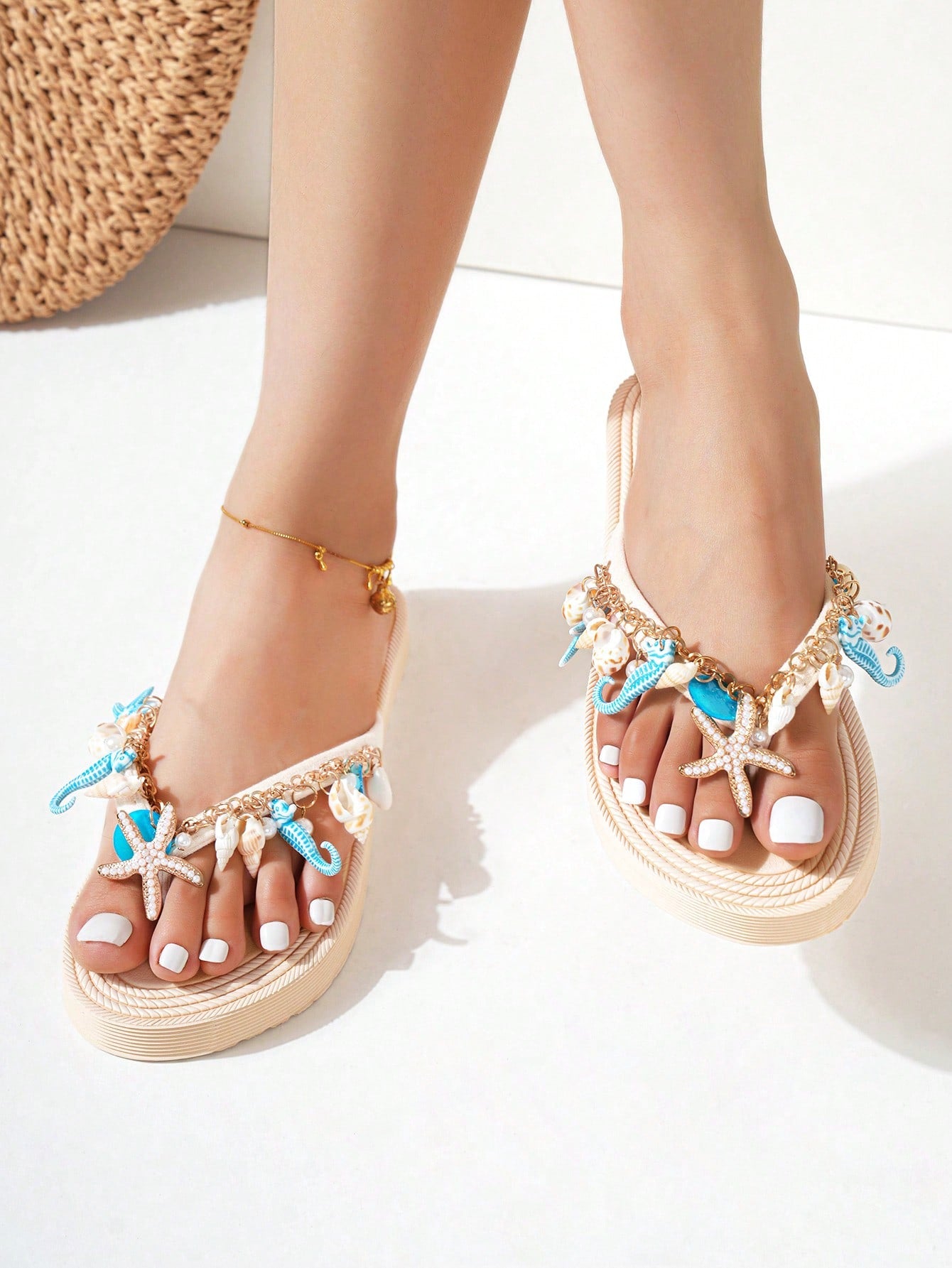 Handmade women’s beach flip flop sandals with shell and starfish rhinestone decorated woven straps, flat thong style, and lightweight non-slip sole.