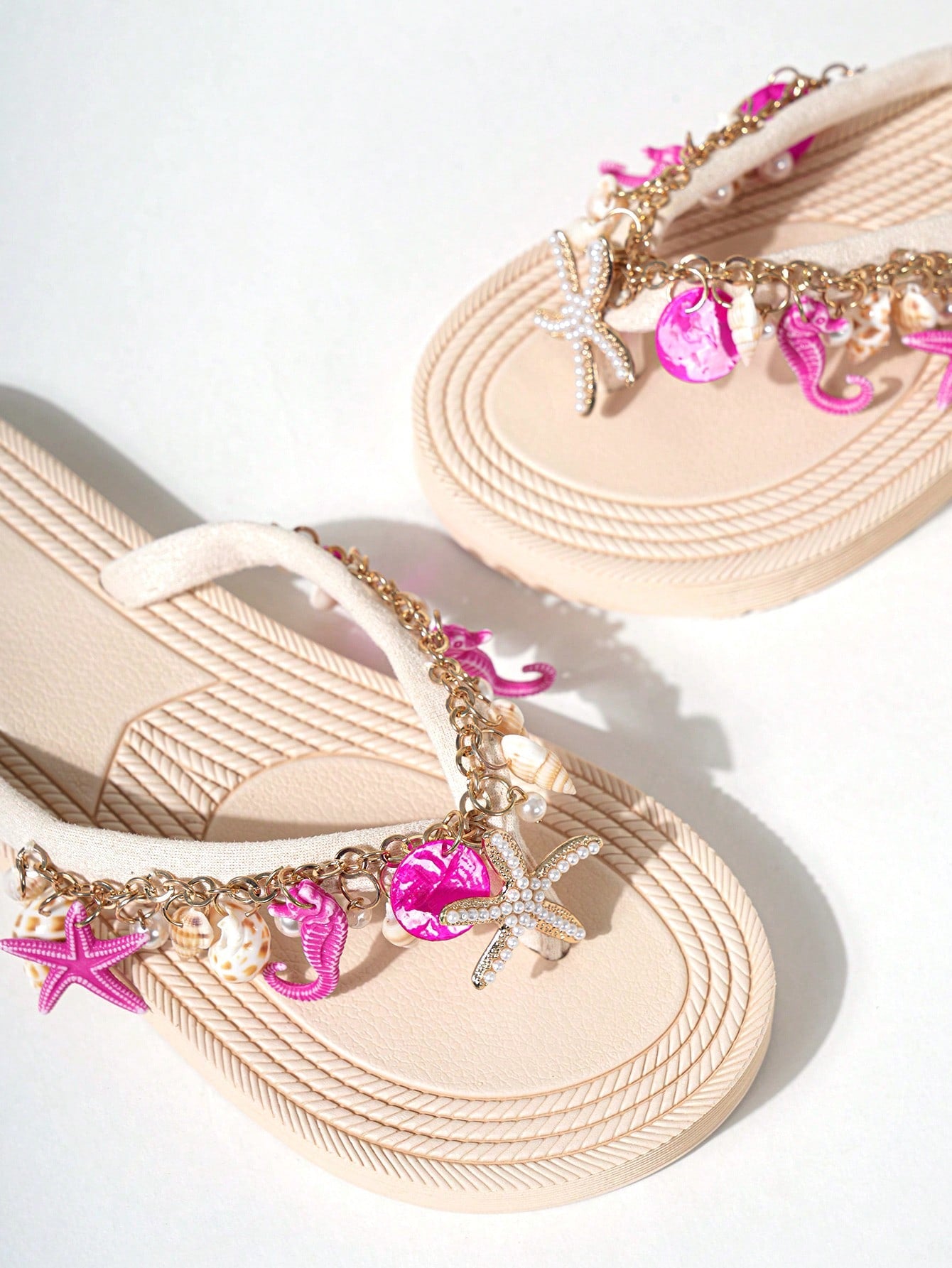 Handmade women’s beach flip flop sandals with shell and starfish rhinestone decorated woven straps, flat thong style, and lightweight non-slip sole.