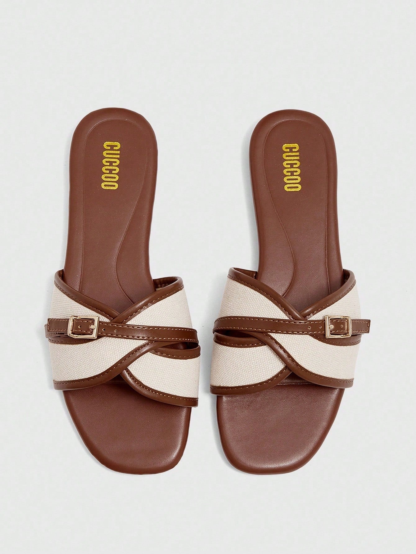 Women's flat slide sandals featuring a simple buckle strap and color block design, in brown tones, with a flat sole for casual vacation and outdoor wear.
