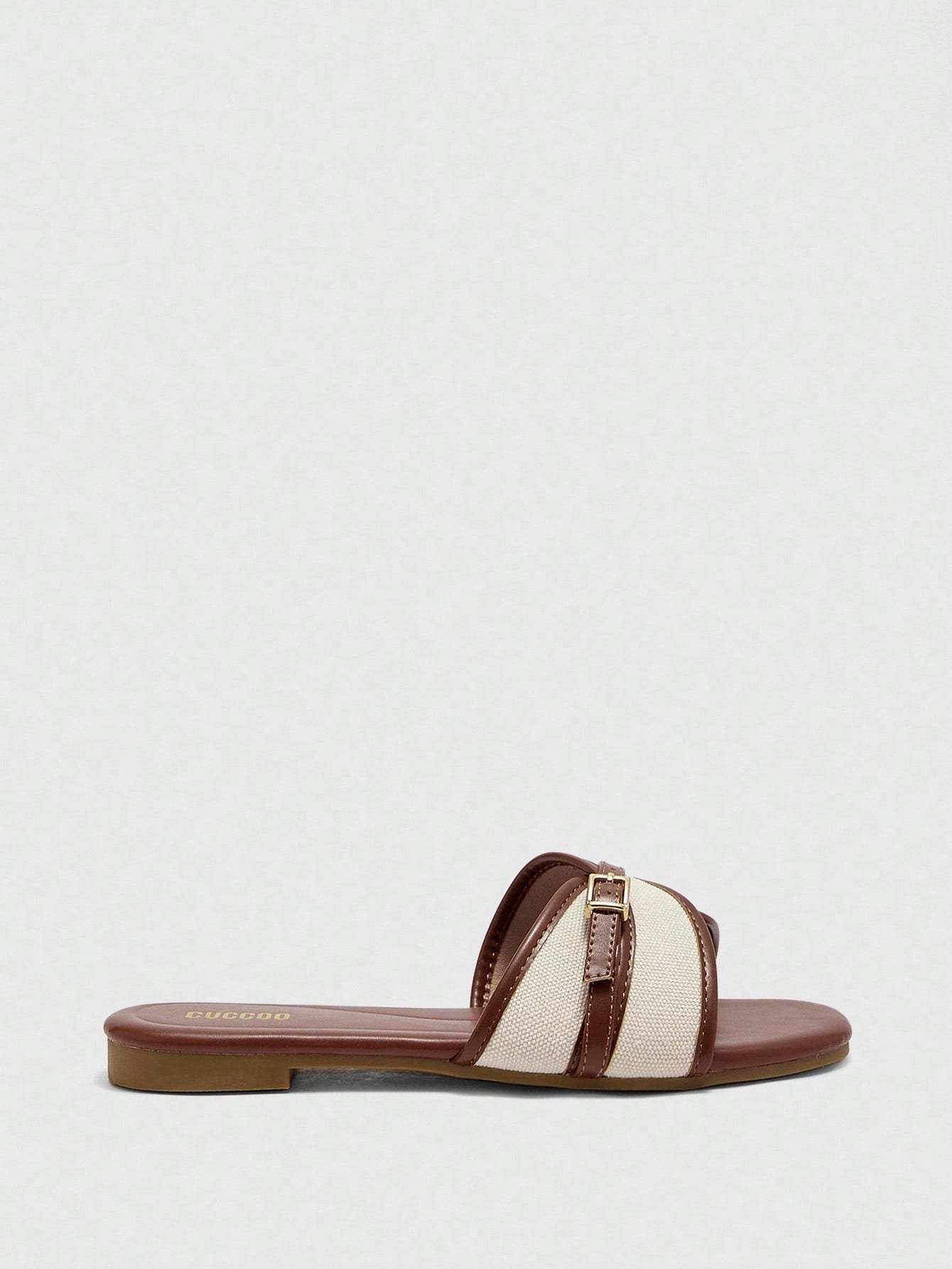 Women's flat slide sandals featuring a simple buckle strap and color block design, in brown tones, with a flat sole for casual vacation and outdoor wear.