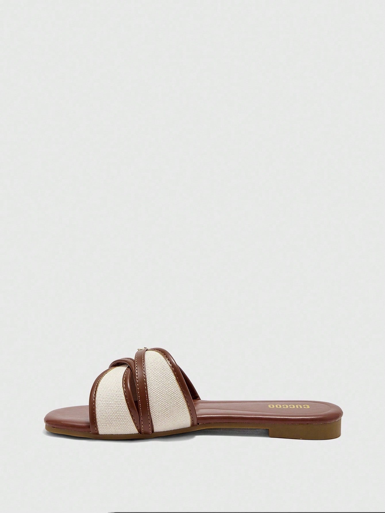Women's flat slide sandals featuring a simple buckle strap and color block design, in brown tones, with a flat sole for casual vacation and outdoor wear.