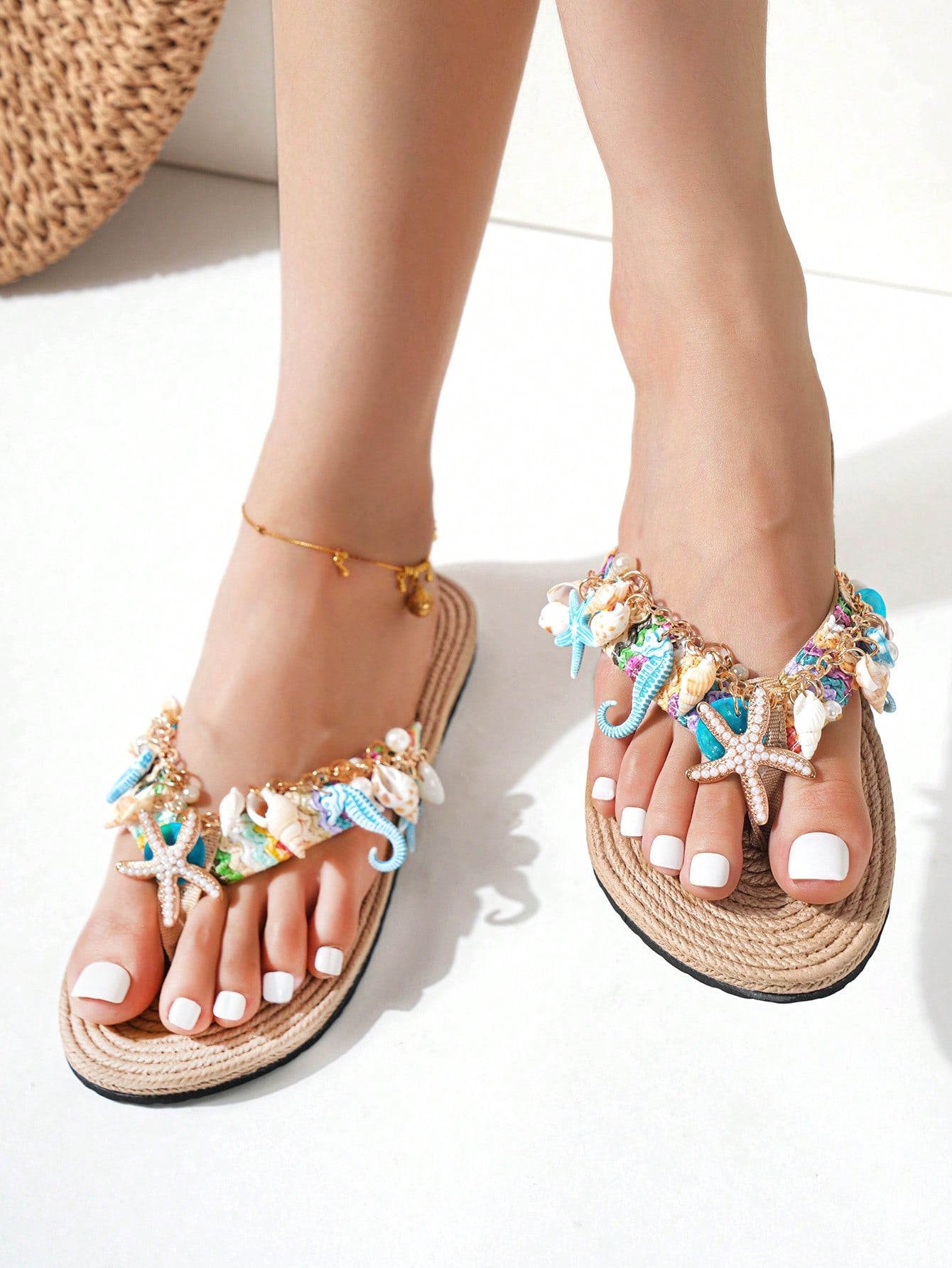Handmade women’s beach flip flop sandals with shell and starfish rhinestone decorated woven straps, flat thong style, and lightweight non-slip sole.