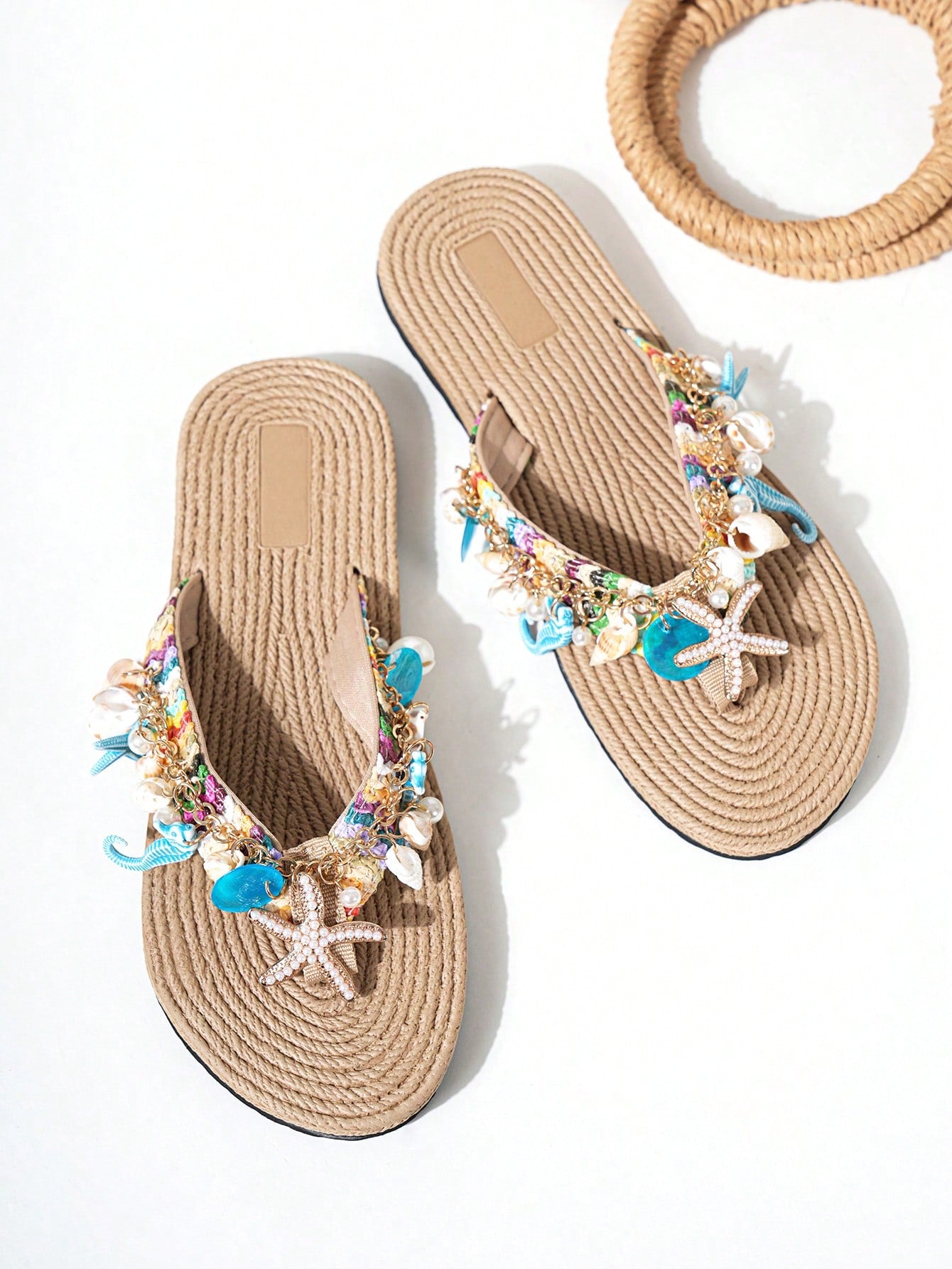 Handmade women’s beach flip flop sandals with shell and starfish rhinestone decorated woven straps, flat thong style, and lightweight non-slip sole.