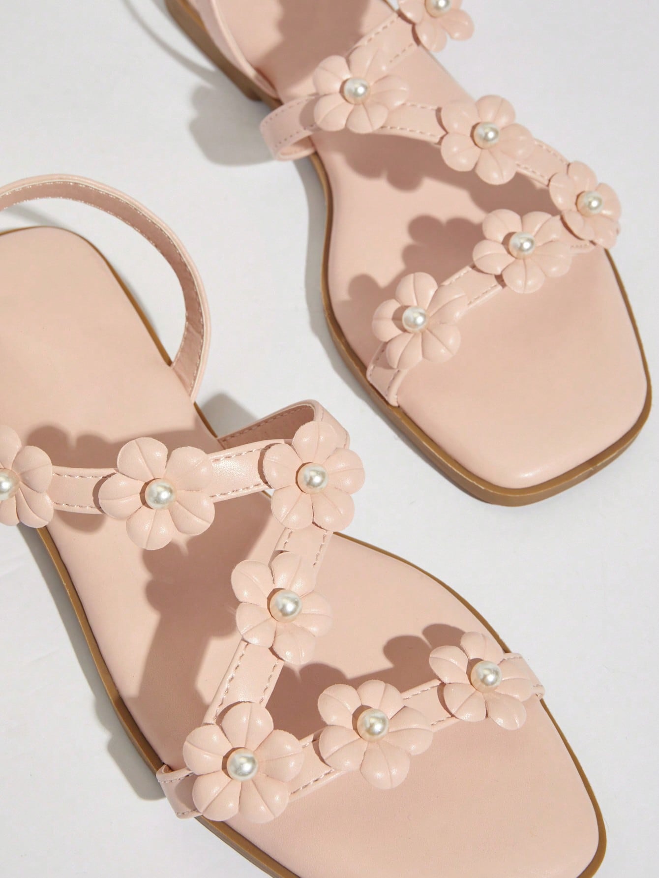 Women's flat open-toe sandals featuring a buckle detail and PU leather construction with a flat sole.