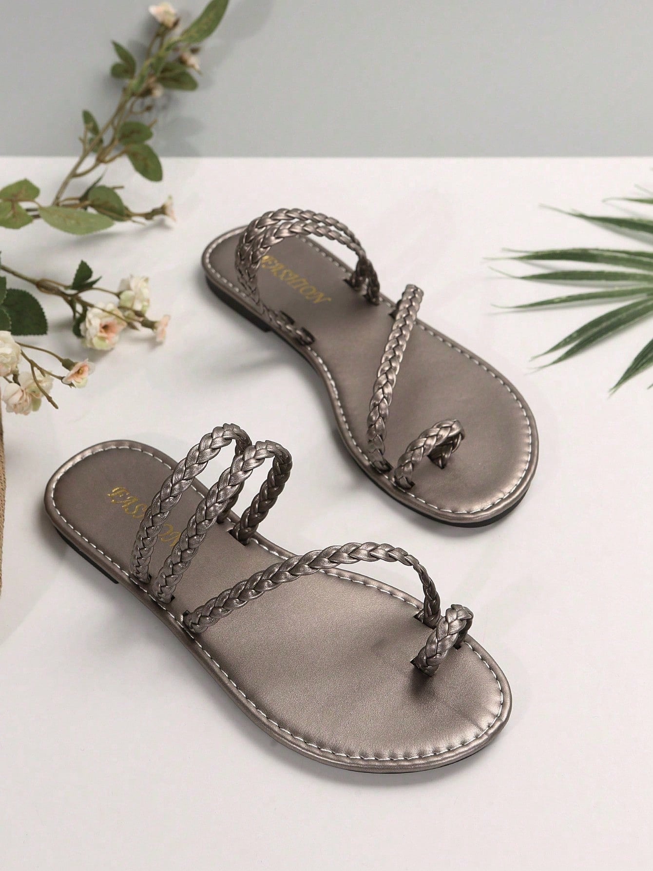 Plus size women's flat slide sandals with woven braid detail and open toe, casual outdoor beach and vacation style.