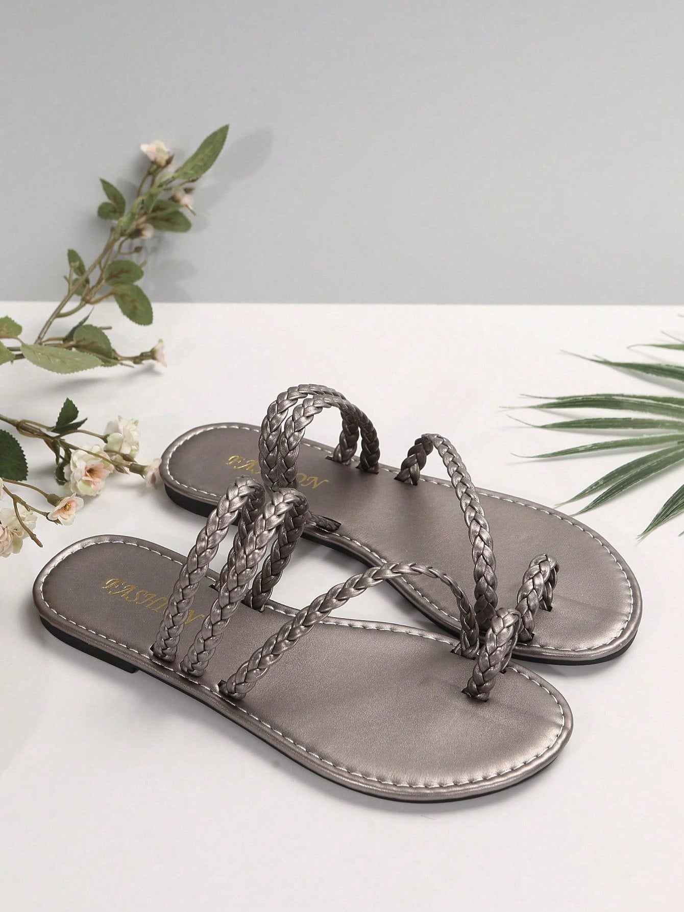 Plus size women's flat slide sandals with woven braid detail and open toe, casual outdoor beach and vacation style.
