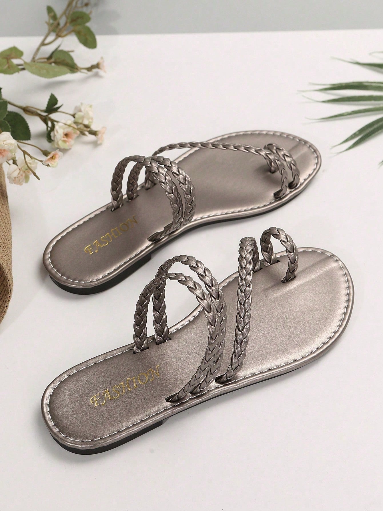 Plus size women's flat slide sandals with woven braid detail and open toe, casual outdoor beach and vacation style.
